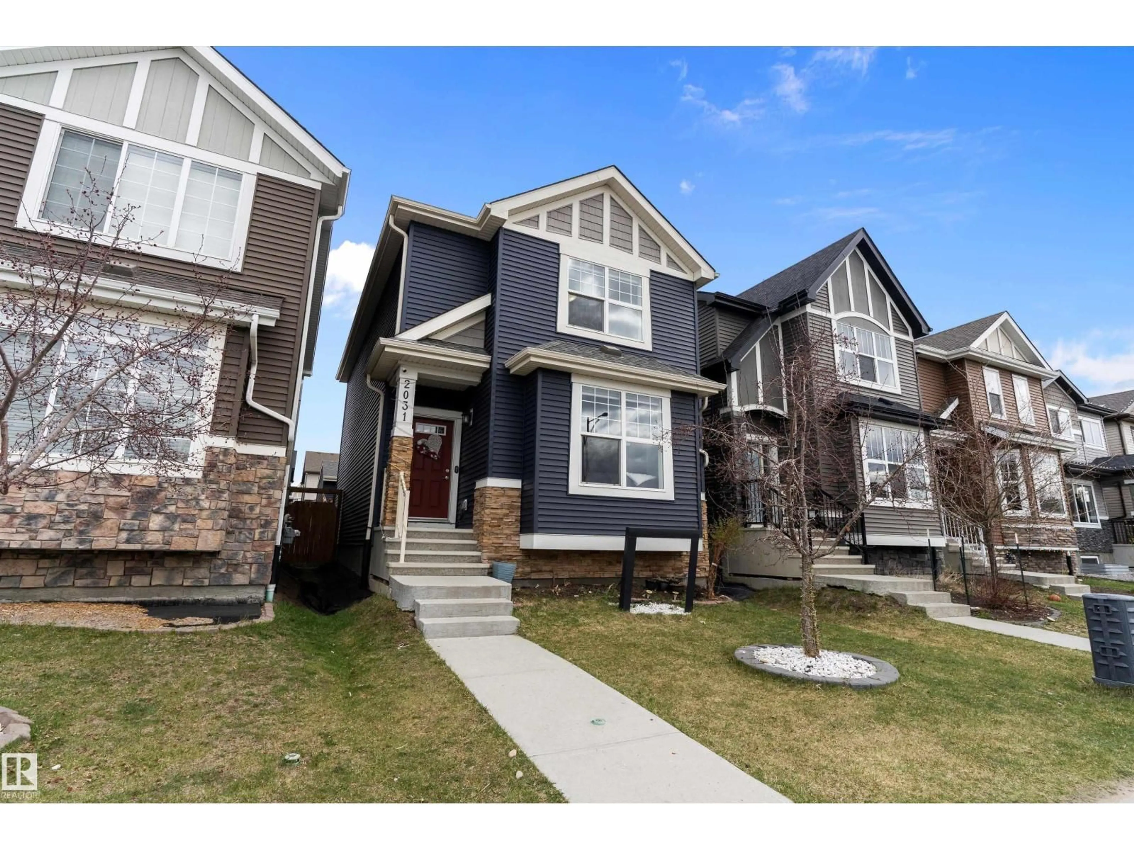 Home with vinyl exterior material, street for 2031 52 STREET, Edmonton Alberta T6X1Z7