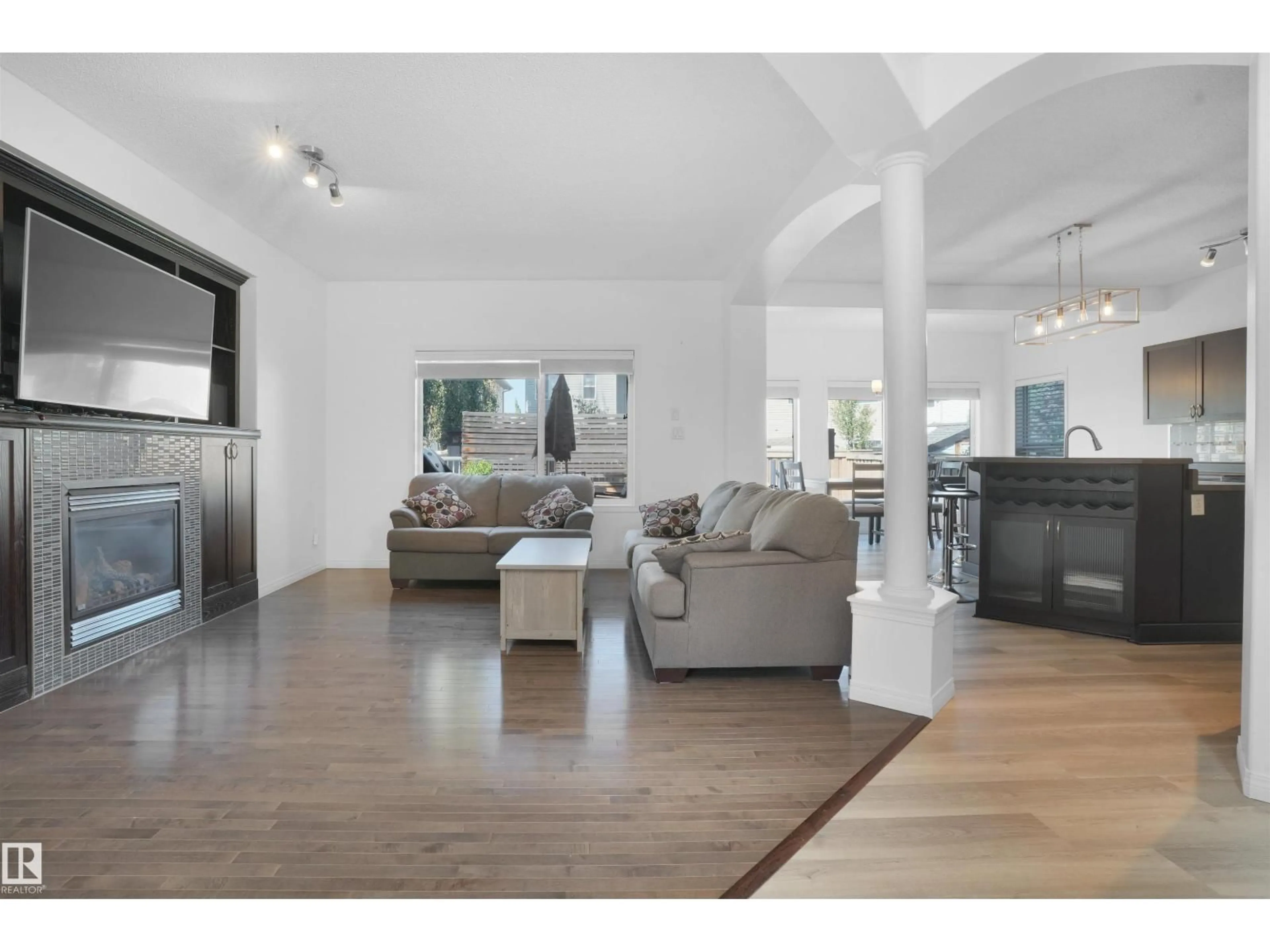 Living room with furniture, wood/laminate floor for 8378 SHASKE CR, Edmonton Alberta T6R0B5