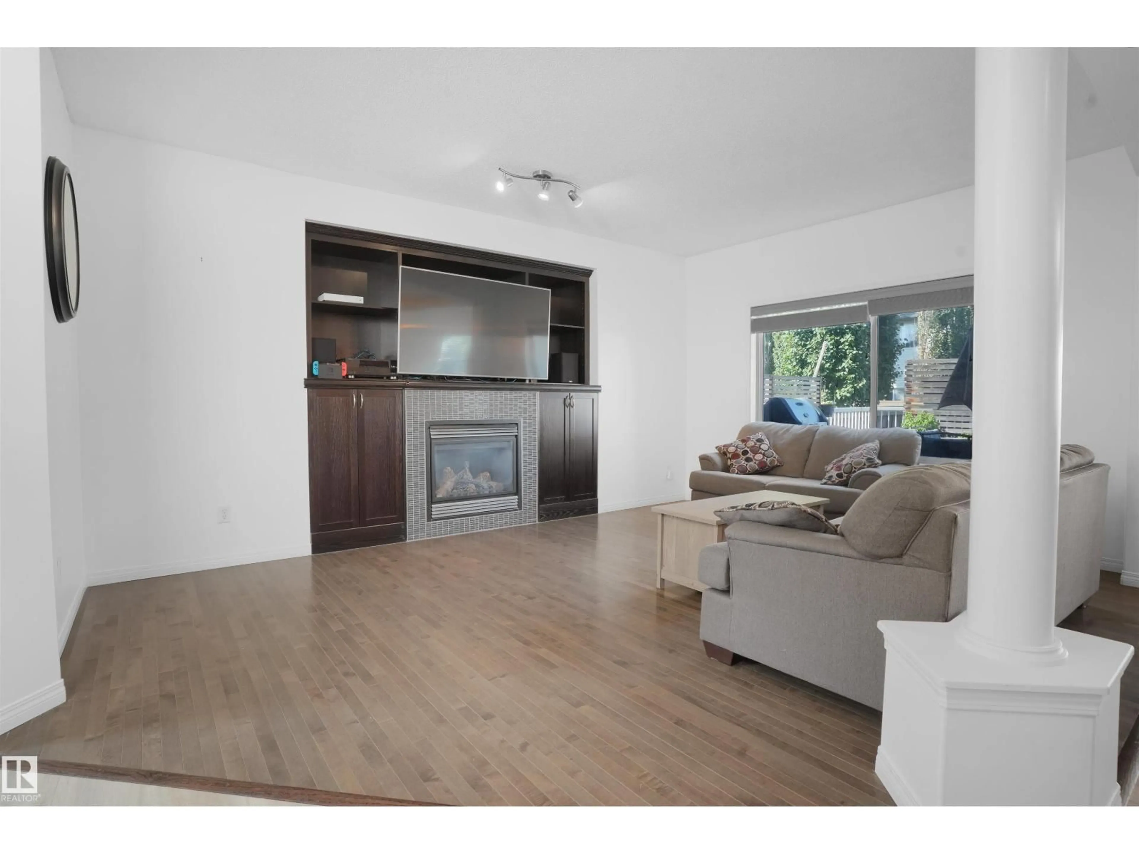 Living room with furniture, wood/laminate floor for 8378 SHASKE CR, Edmonton Alberta T6R0B5