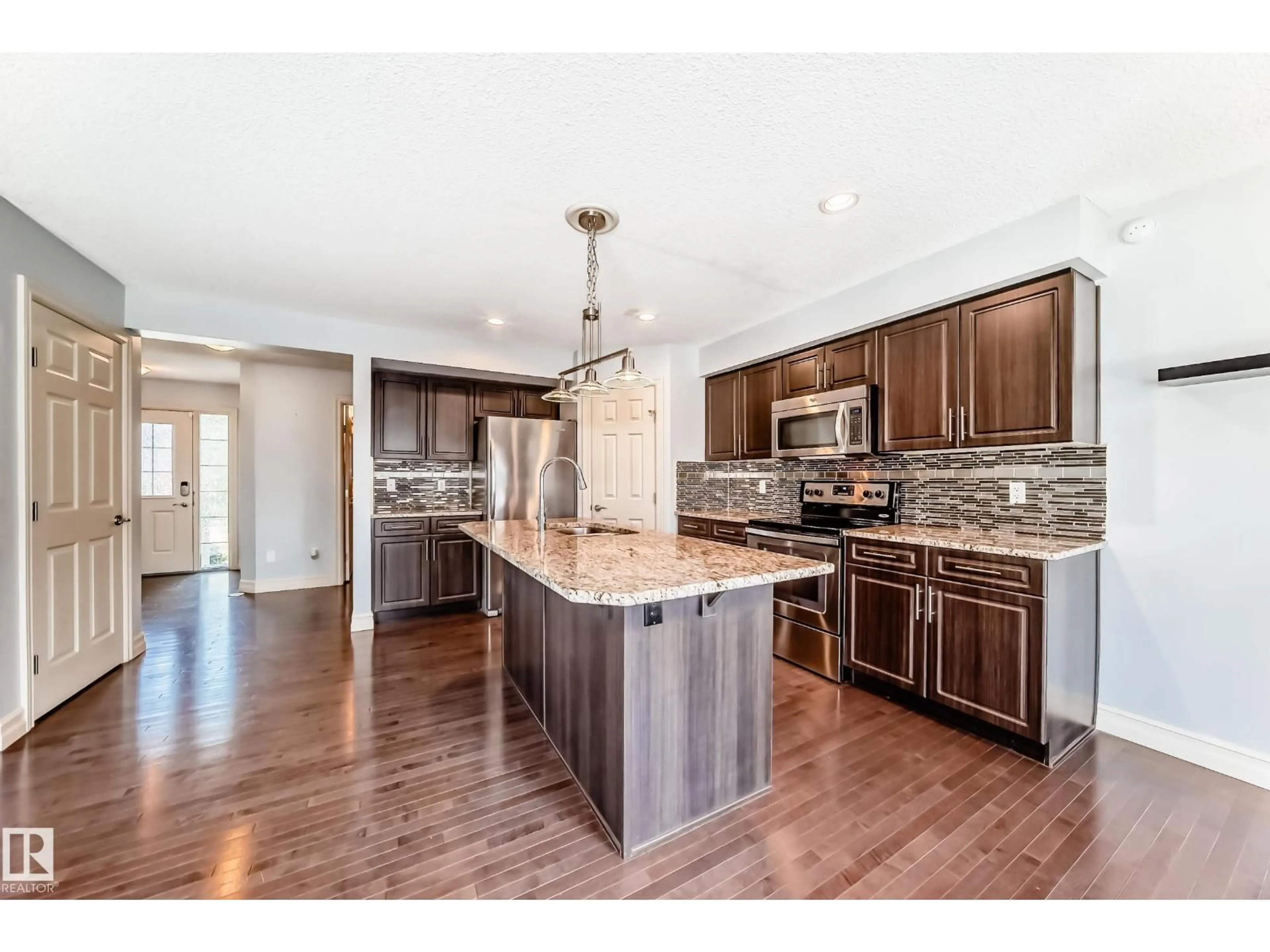 Open concept kitchen, wood/laminate floor for 20 DICKENS ST, Fort Saskatchewan Alberta T8L0M8