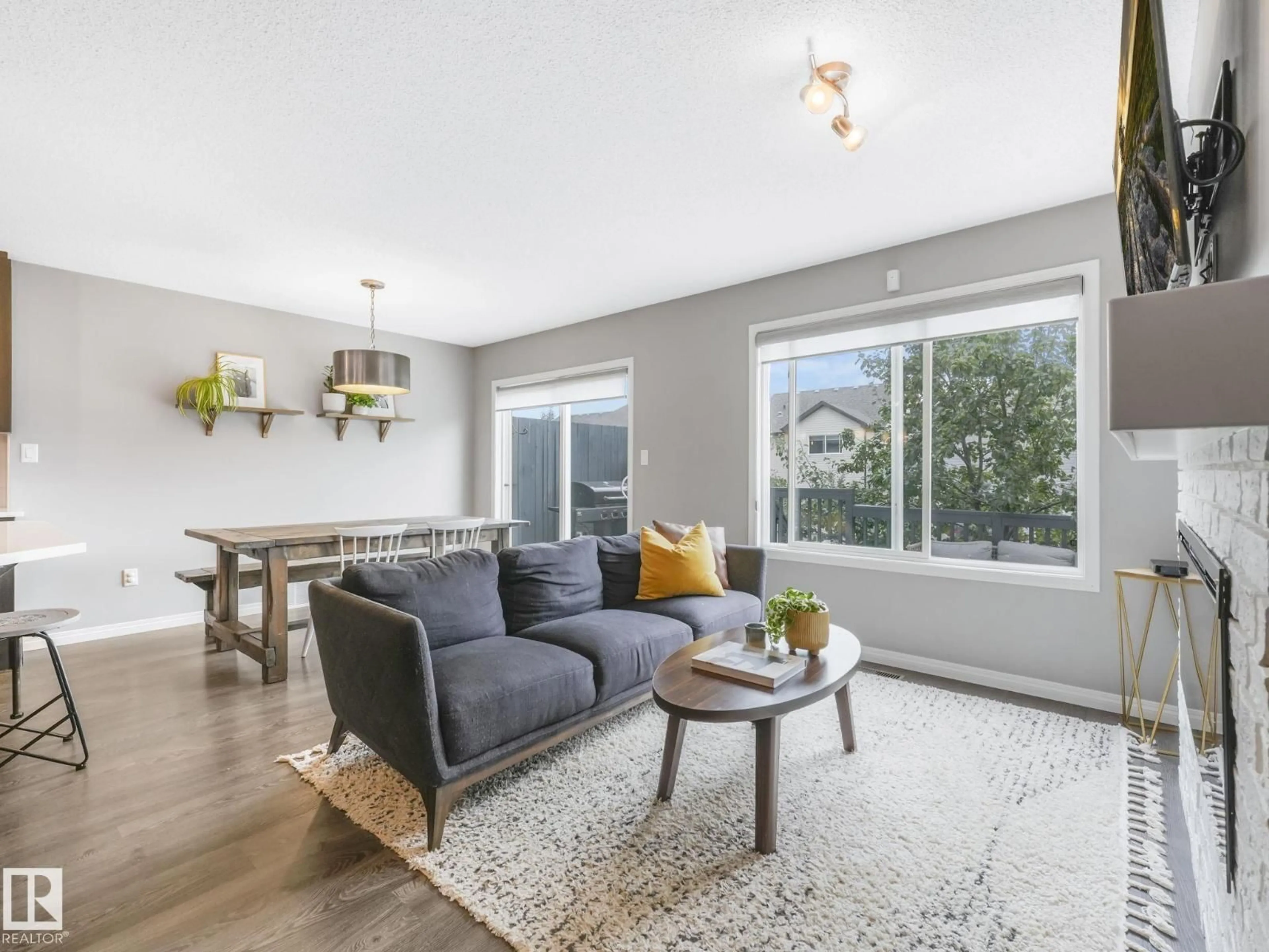 Living room with furniture, wood/laminate floor for SW - 1671 CHAPMAN WY, Edmonton Alberta T6W0Y5