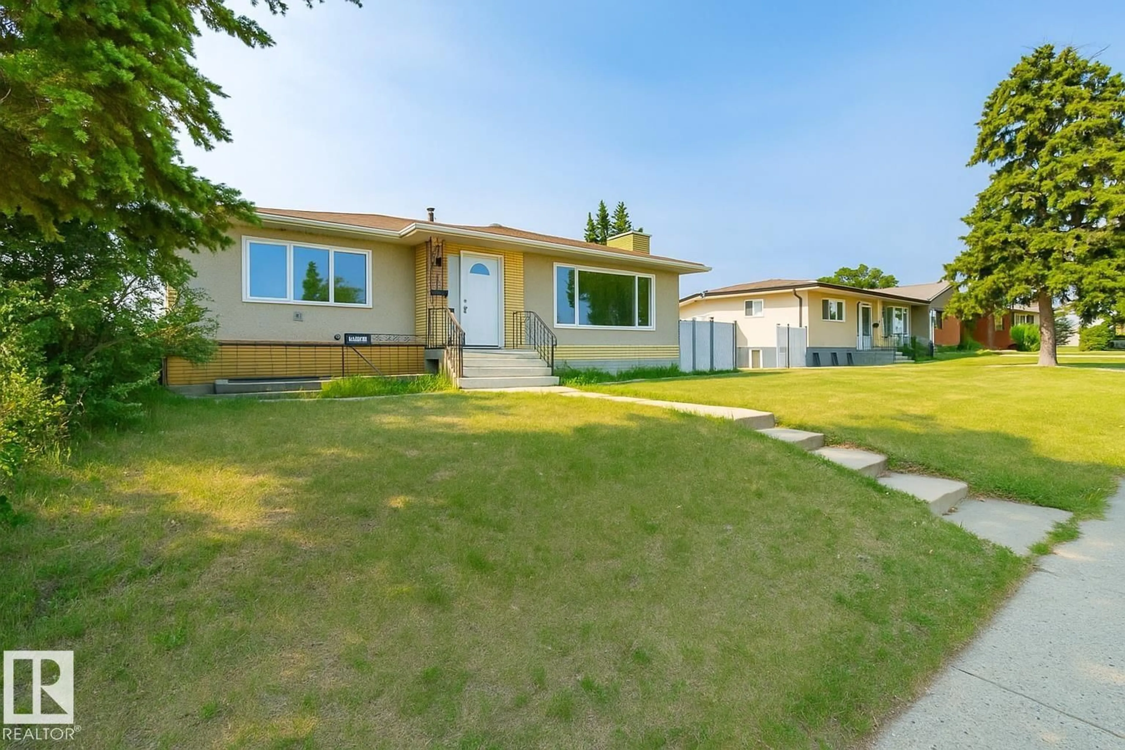 Home with vinyl exterior material, street for 8911 132 AV NW, Edmonton Alberta T5X0X9