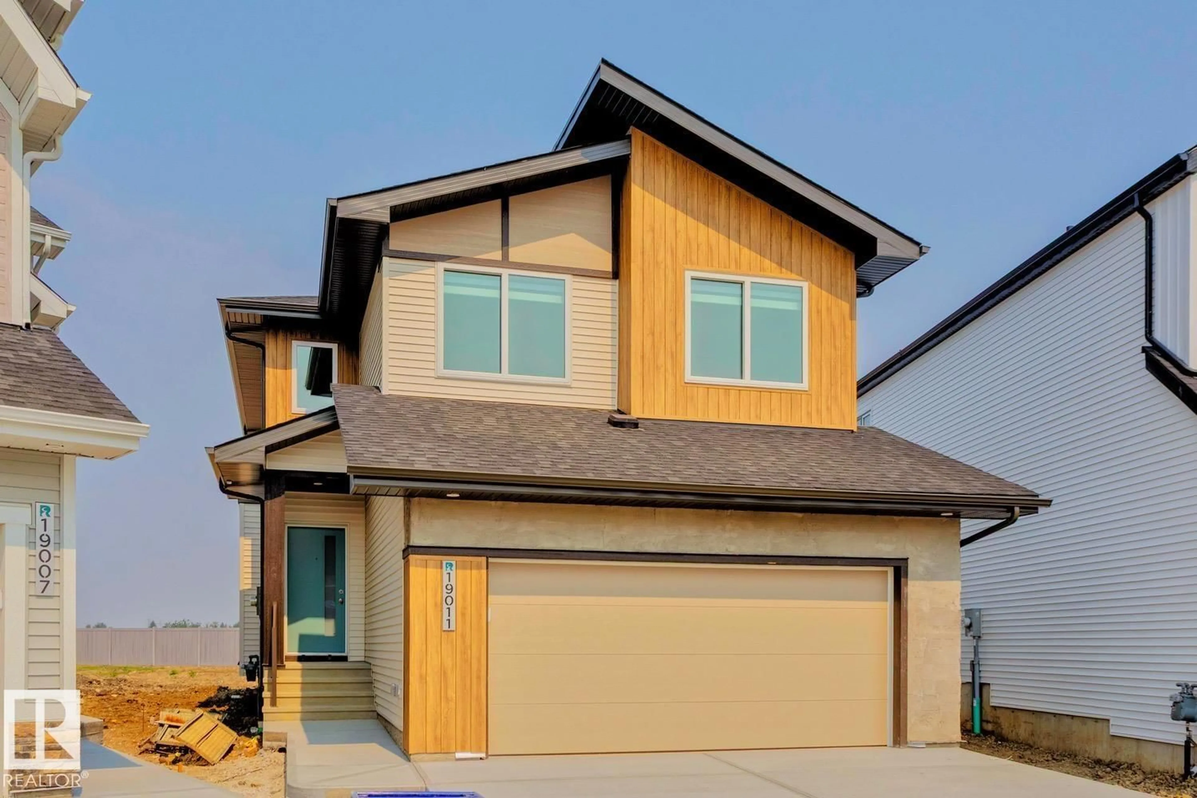 Home with vinyl exterior material, street for 19011 20 AV, Edmonton Alberta T6M2N6