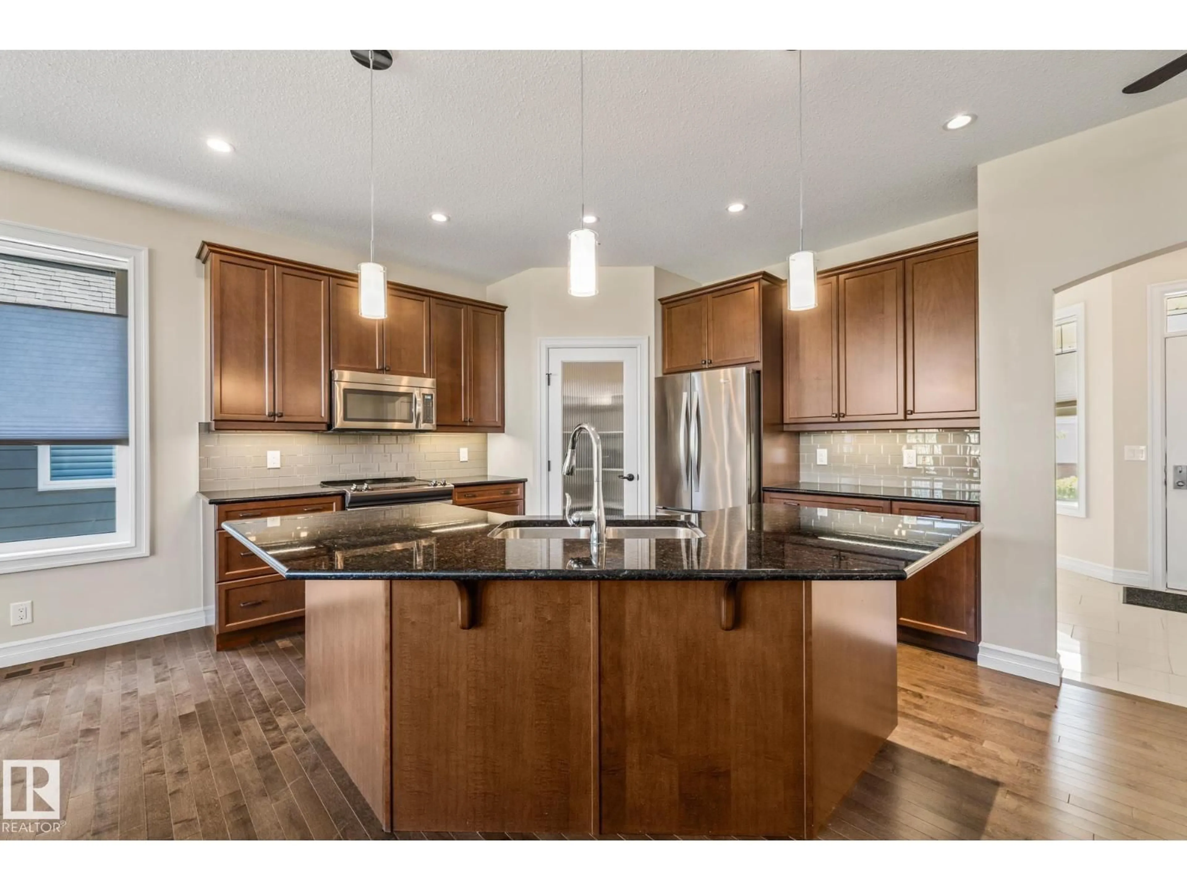 Open concept kitchen, wood/laminate floor for 18343 - 63 LESSARD RD, Edmonton Alberta T6M2Y5