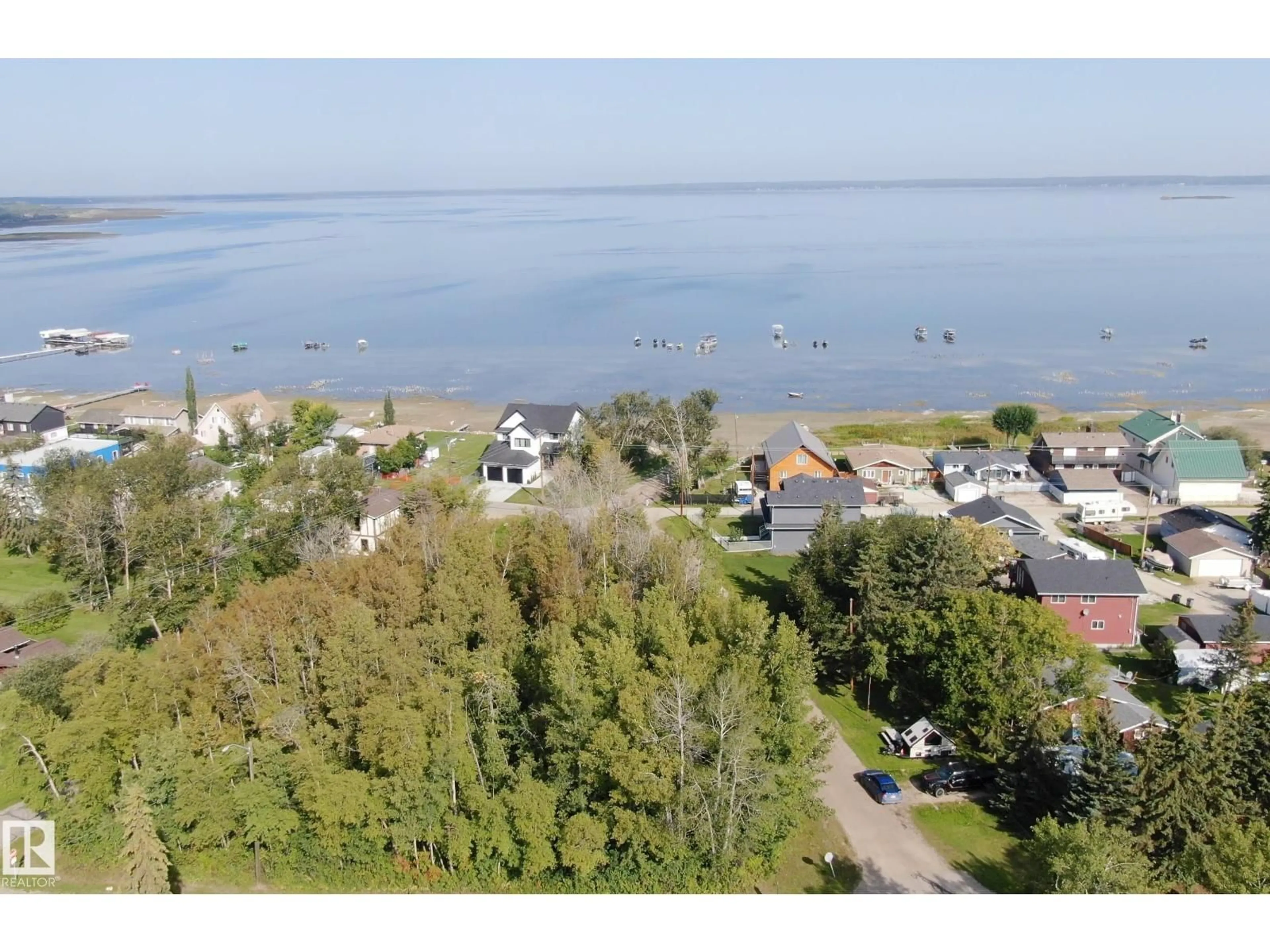 A pic from outside/outdoor area/front of a property/back of a property/a pic from drone, water/lake/river/ocean view for 5912 49 AV, Rural Lac Ste. Anne County Alberta T0E0A0