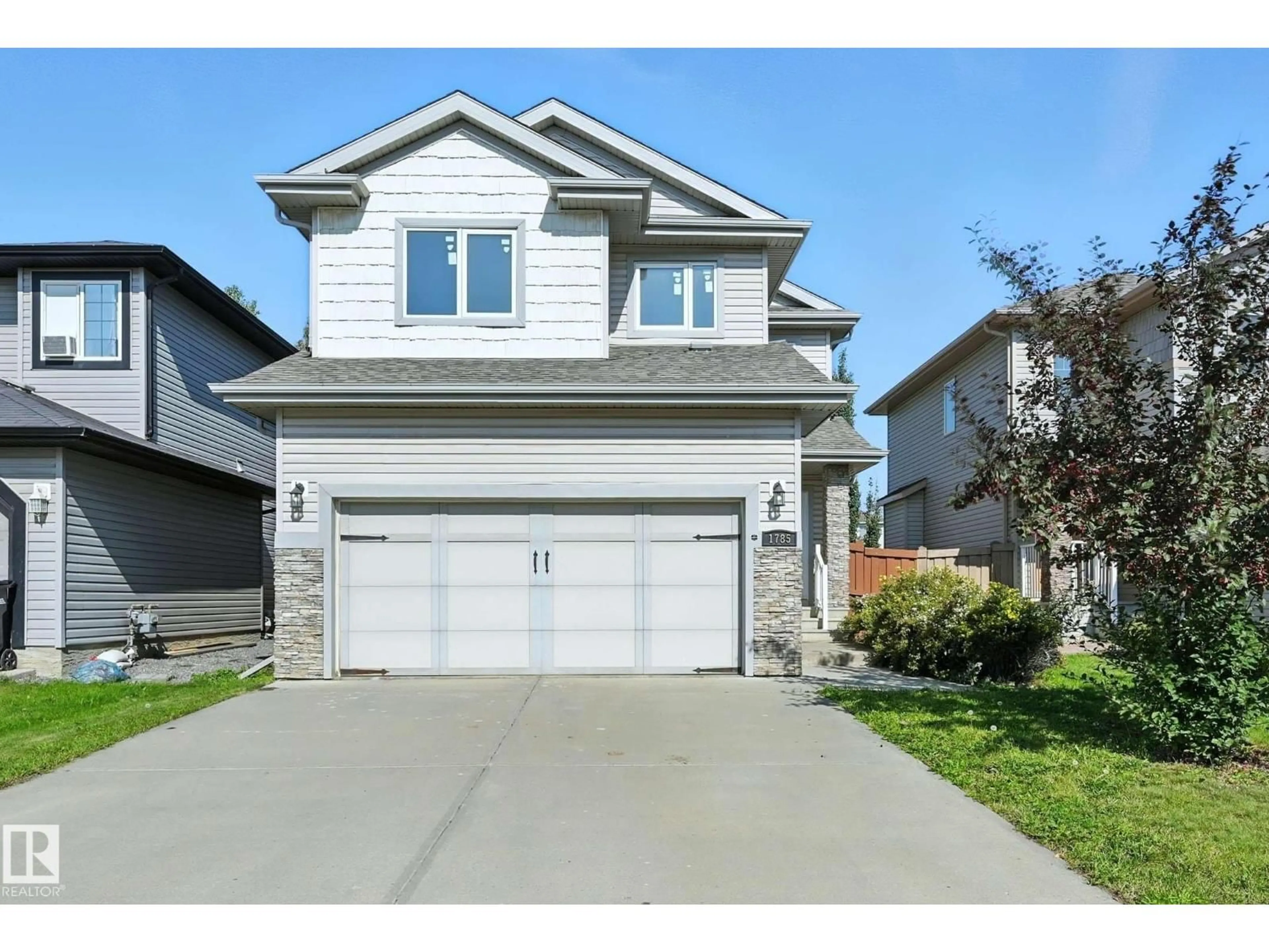 Home with vinyl exterior material, street for 1785 HAMMOND CR, Edmonton Alberta T6M0K3