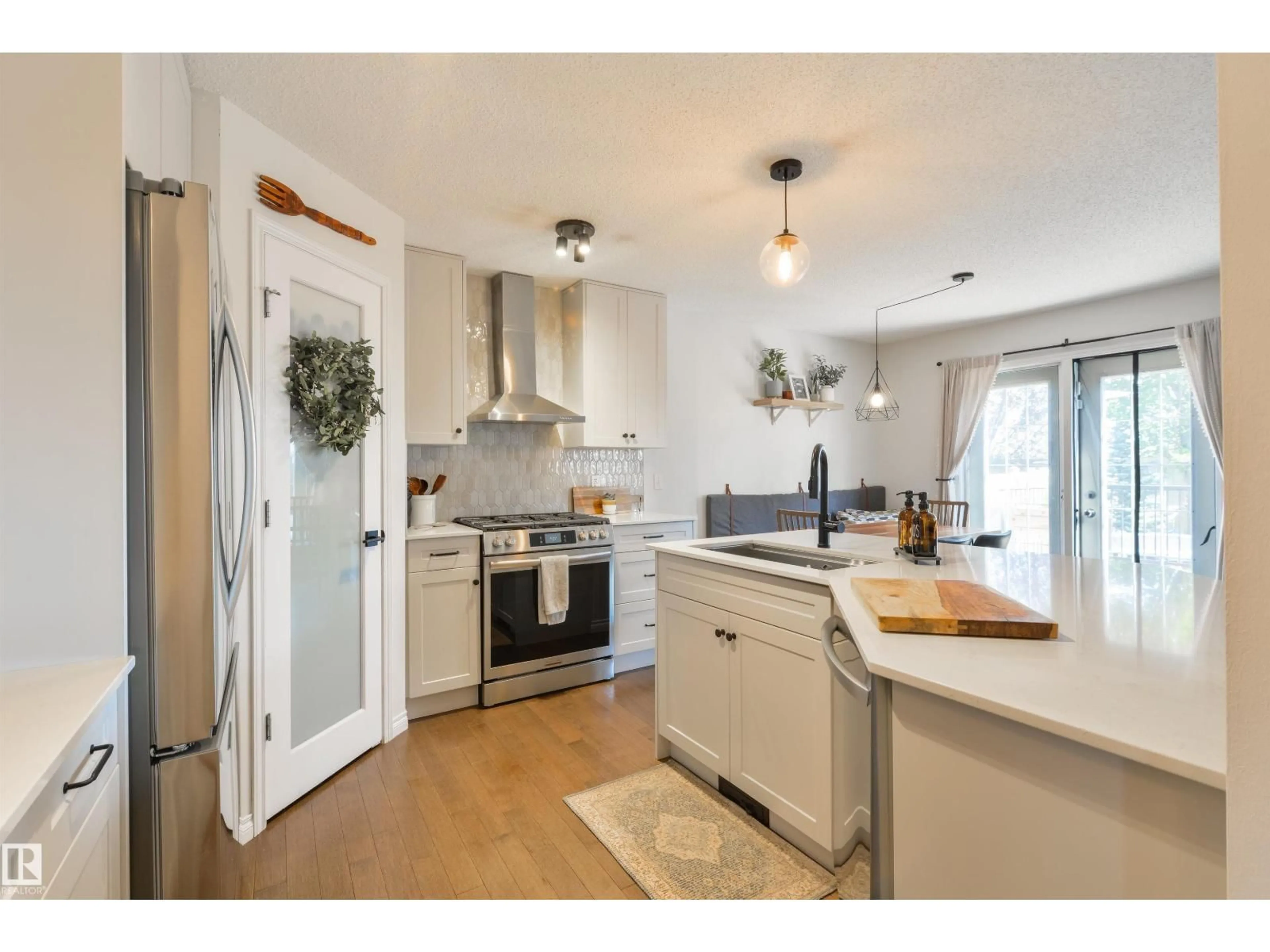 Open concept kitchen, wood/laminate floor for 26 LEYLAND WY, Spruce Grove Alberta T7X4S2