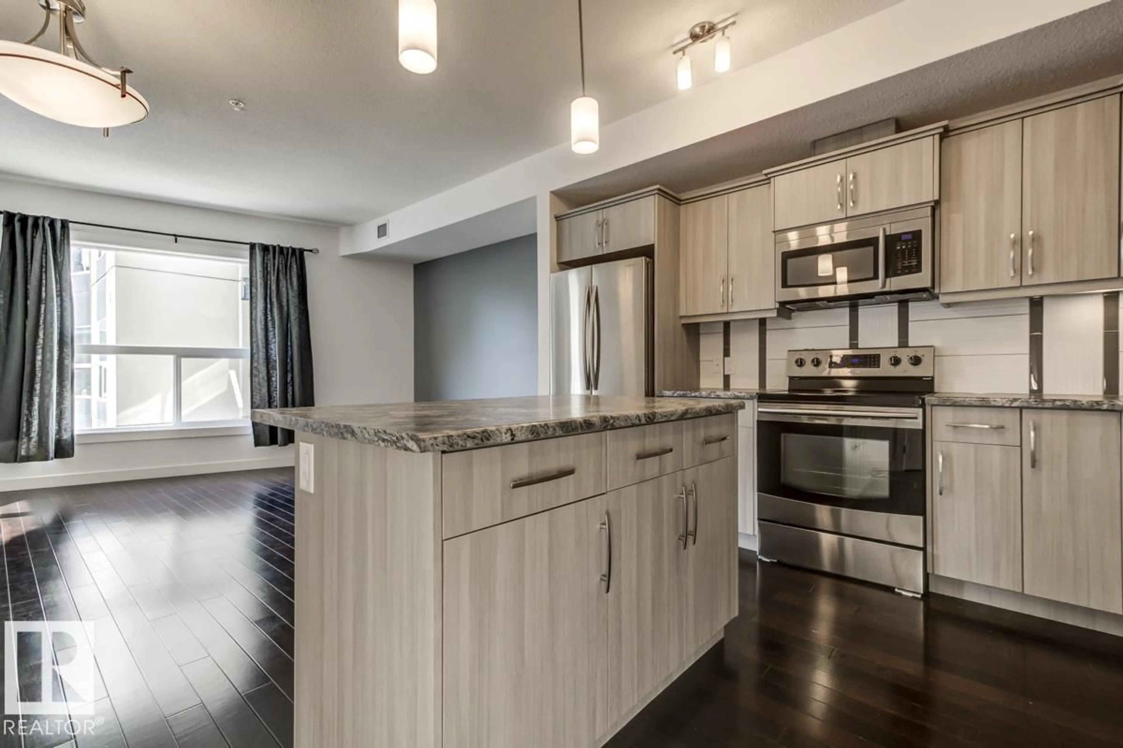 Open concept kitchen, wood/laminate floor for #219 - 10523 123 ST, Edmonton Alberta T5N1W9