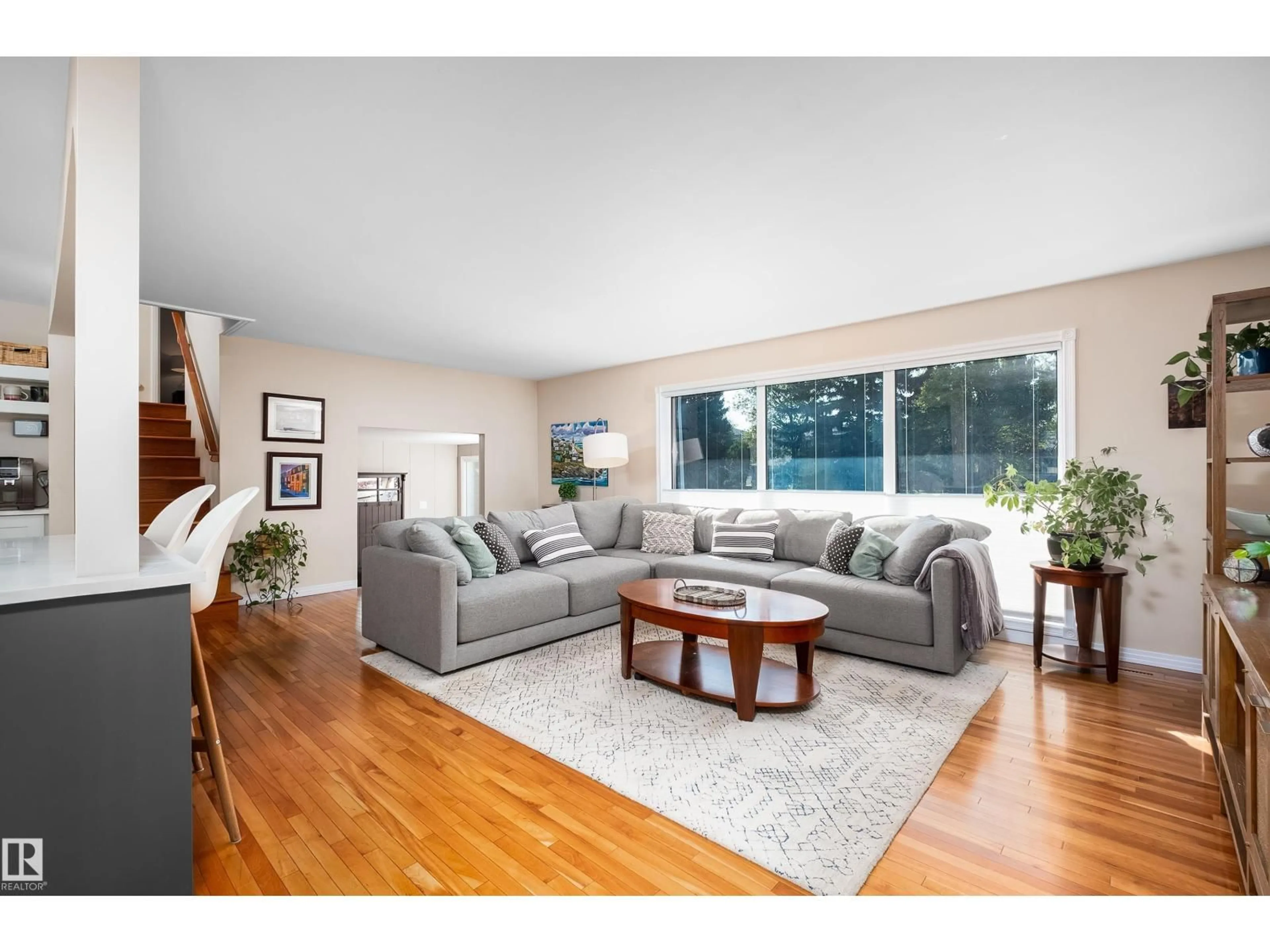 Living room with furniture, wood/laminate floor for 7708 106A AV, Edmonton Alberta T6A1K6