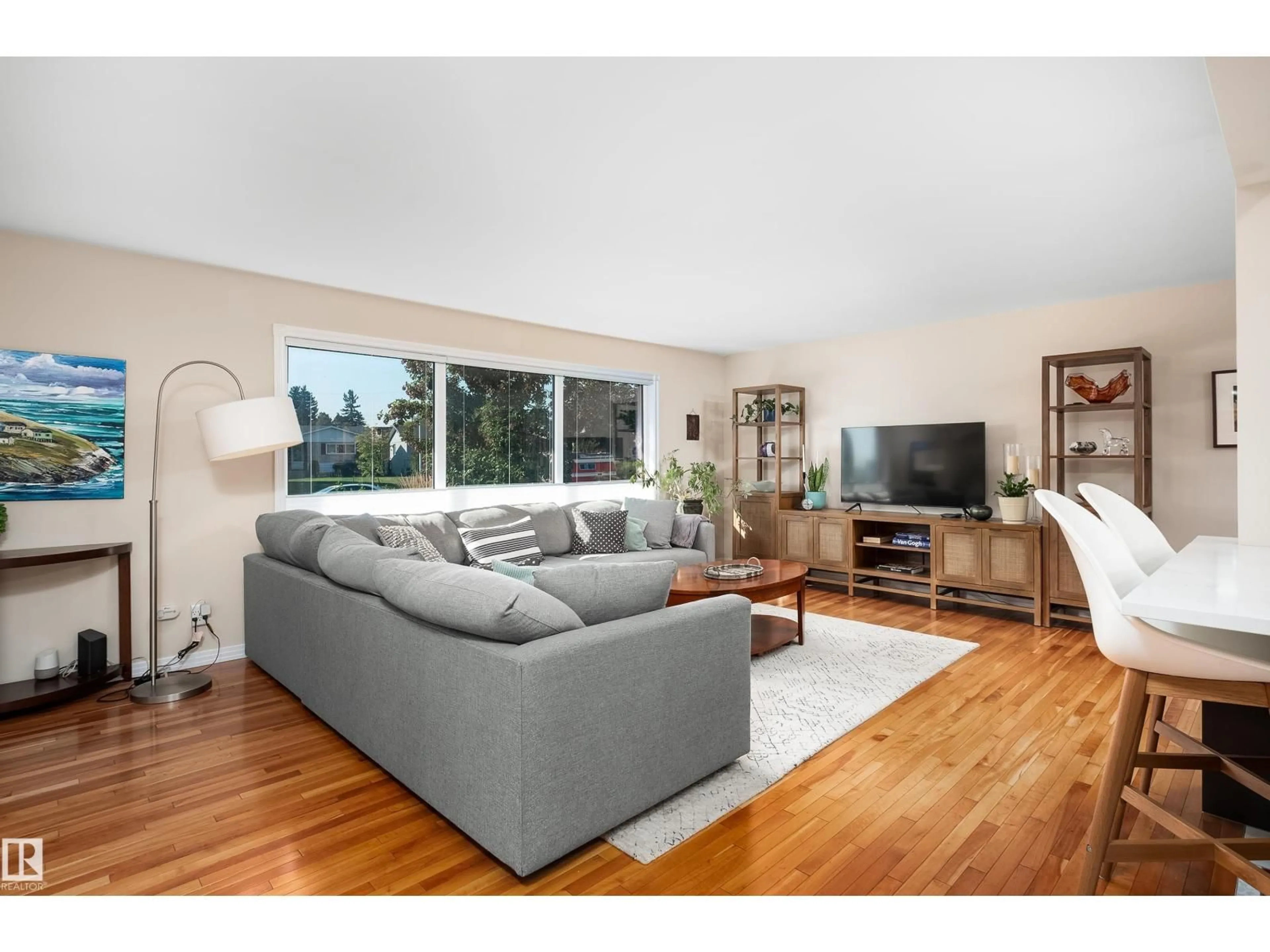 Living room with furniture, wood/laminate floor for 7708 106A AV, Edmonton Alberta T6A1K6