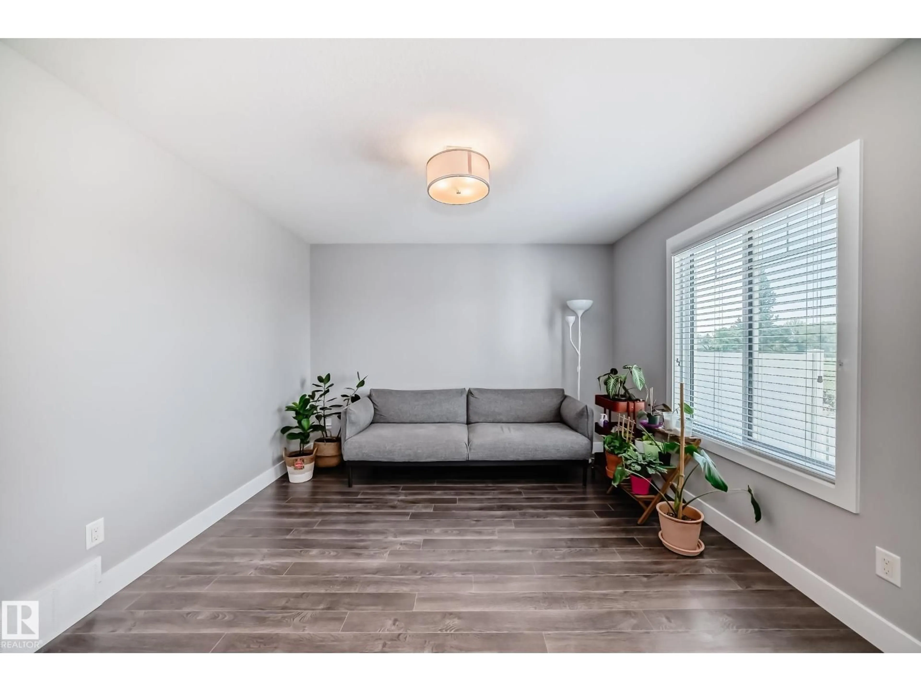 Living room with furniture, wood/laminate floor for 20 - 1508 105 ST NW, Edmonton Alberta T6J5R8