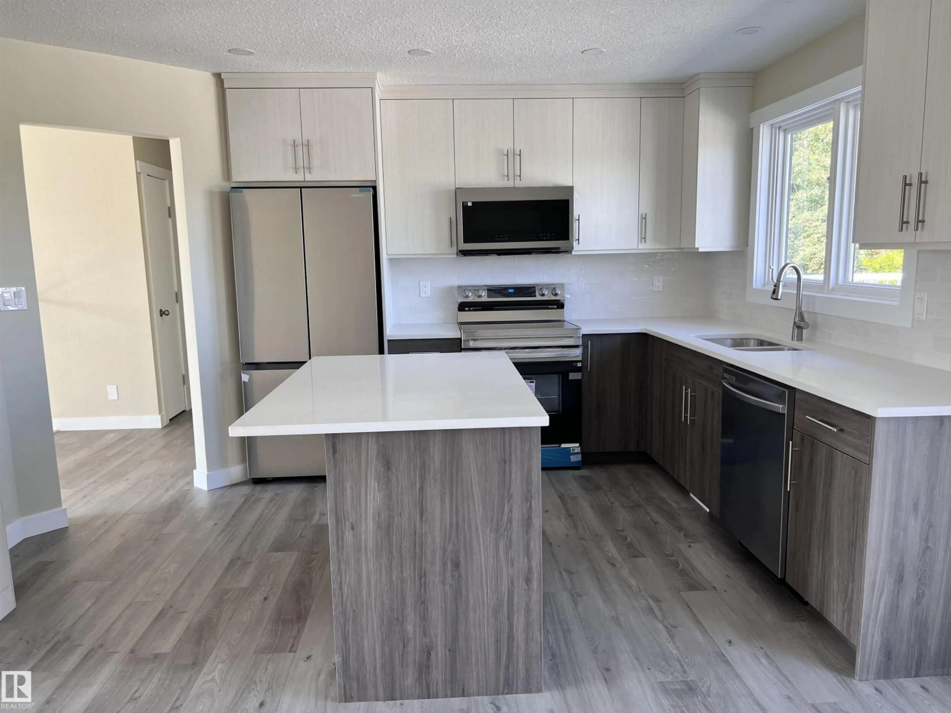 Open concept kitchen, wood/laminate floor for 4036 55 AVENUE, Drayton Valley Alberta T7A1B2