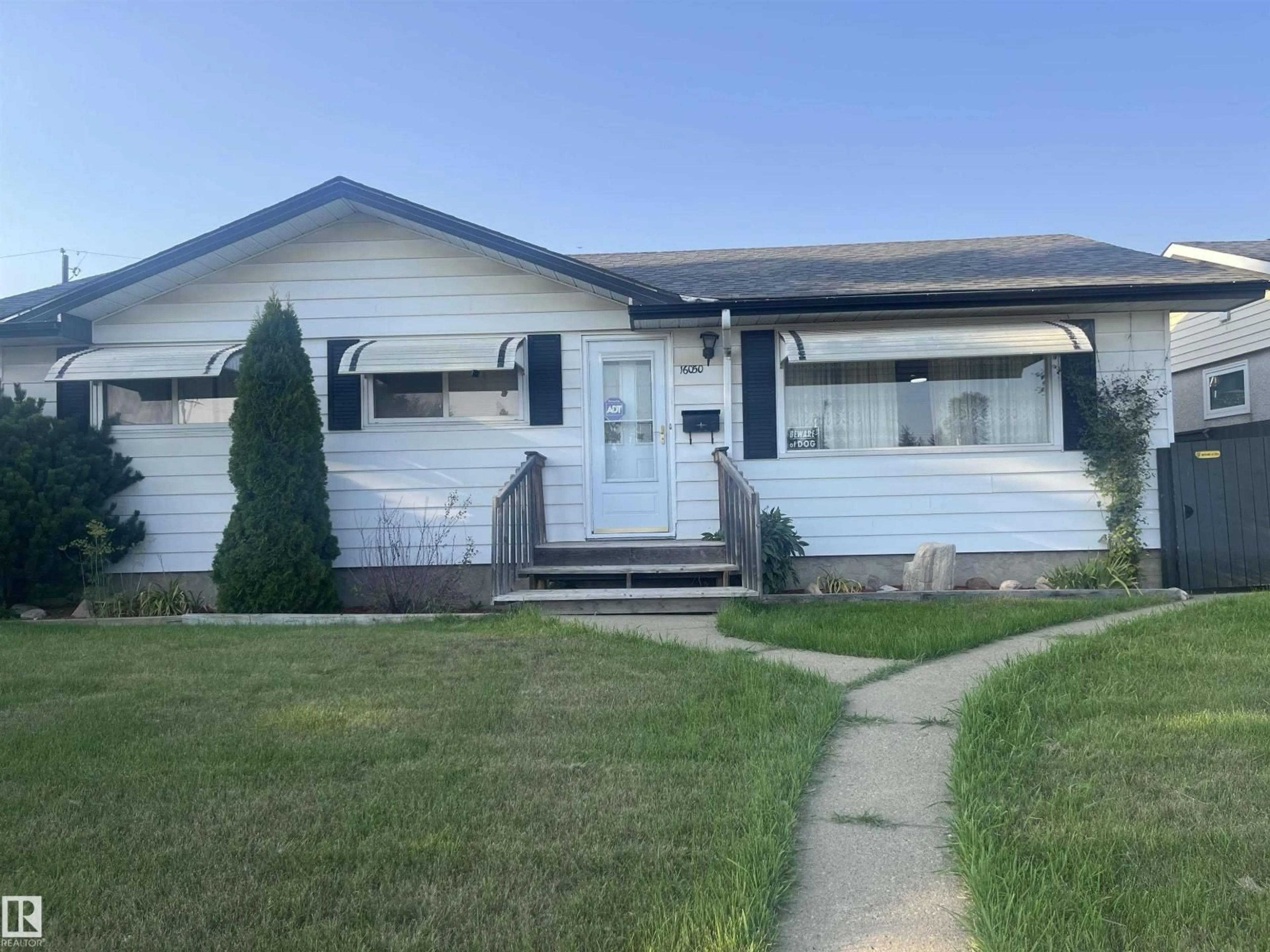 Home with vinyl exterior material, street for 16050 95 AV, Edmonton Alberta T5P0A7