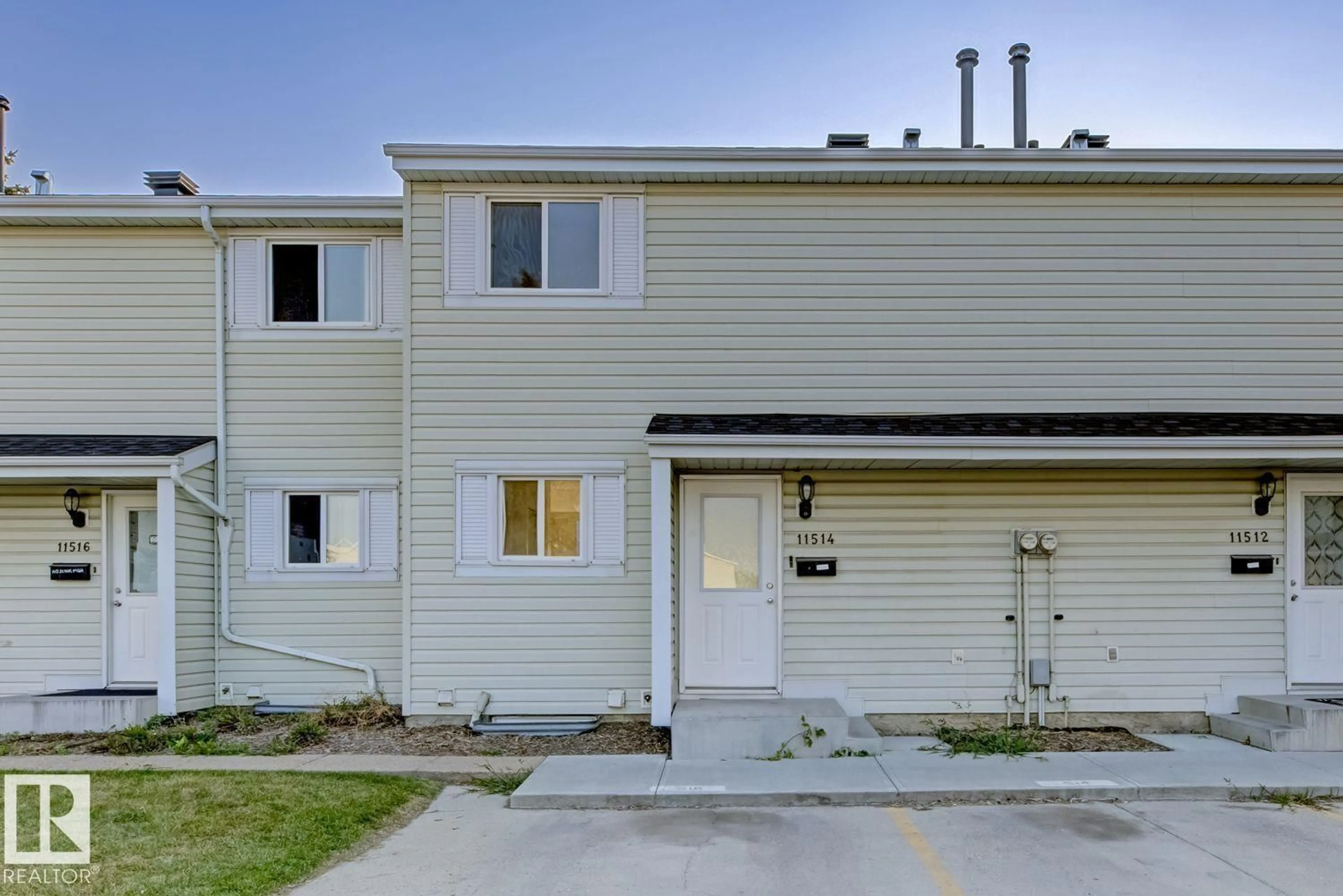 Home with vinyl exterior material, street for 11514 139 AV, Edmonton Alberta T5X3L4