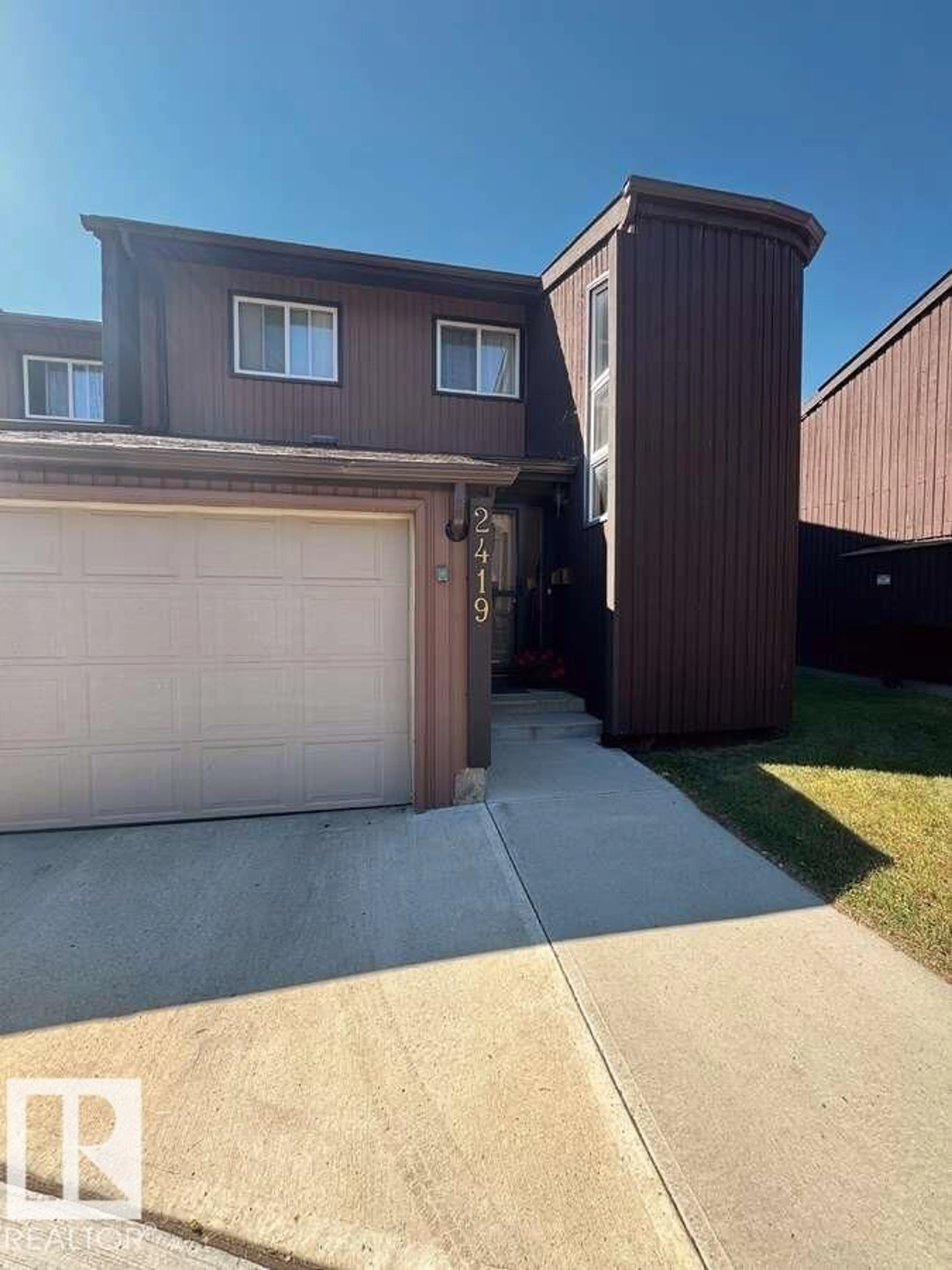 Home with vinyl exterior material, street for 2419 142 AV, Edmonton Alberta T5Y1Y3