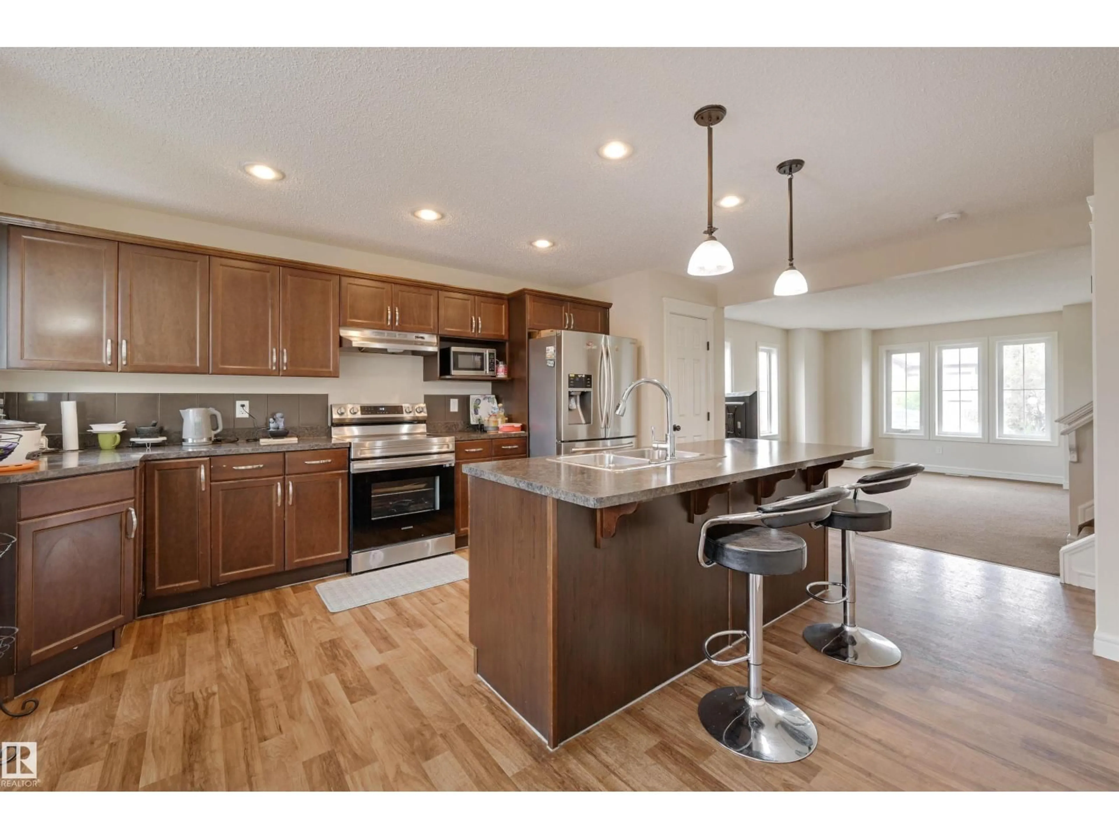 Open concept kitchen, wood/laminate floor for SW - 1807 52 ST, Edmonton Alberta T6X1Y1