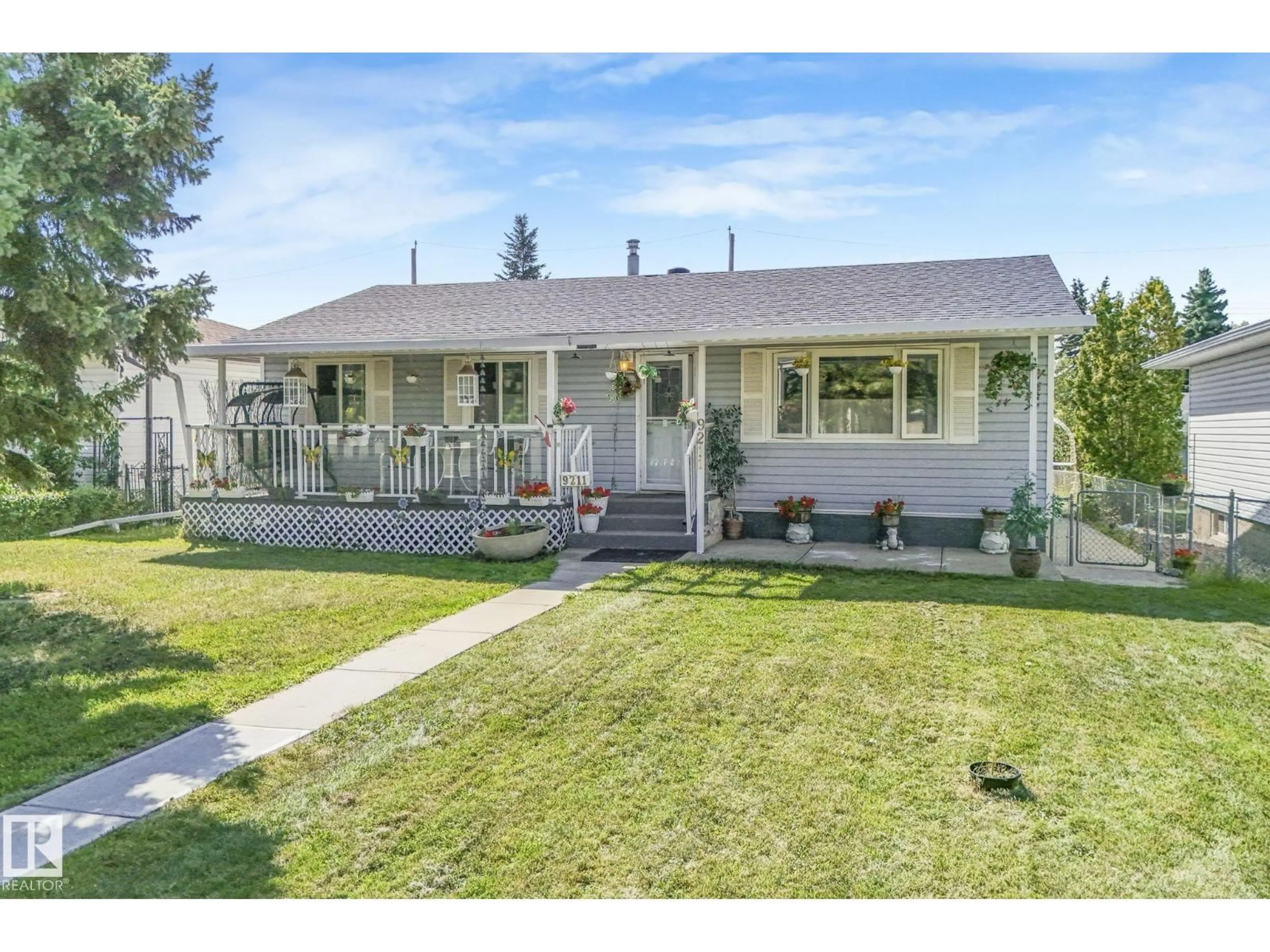 Home with vinyl exterior material, street for 9211 130 AV, Edmonton Alberta T5E0S1