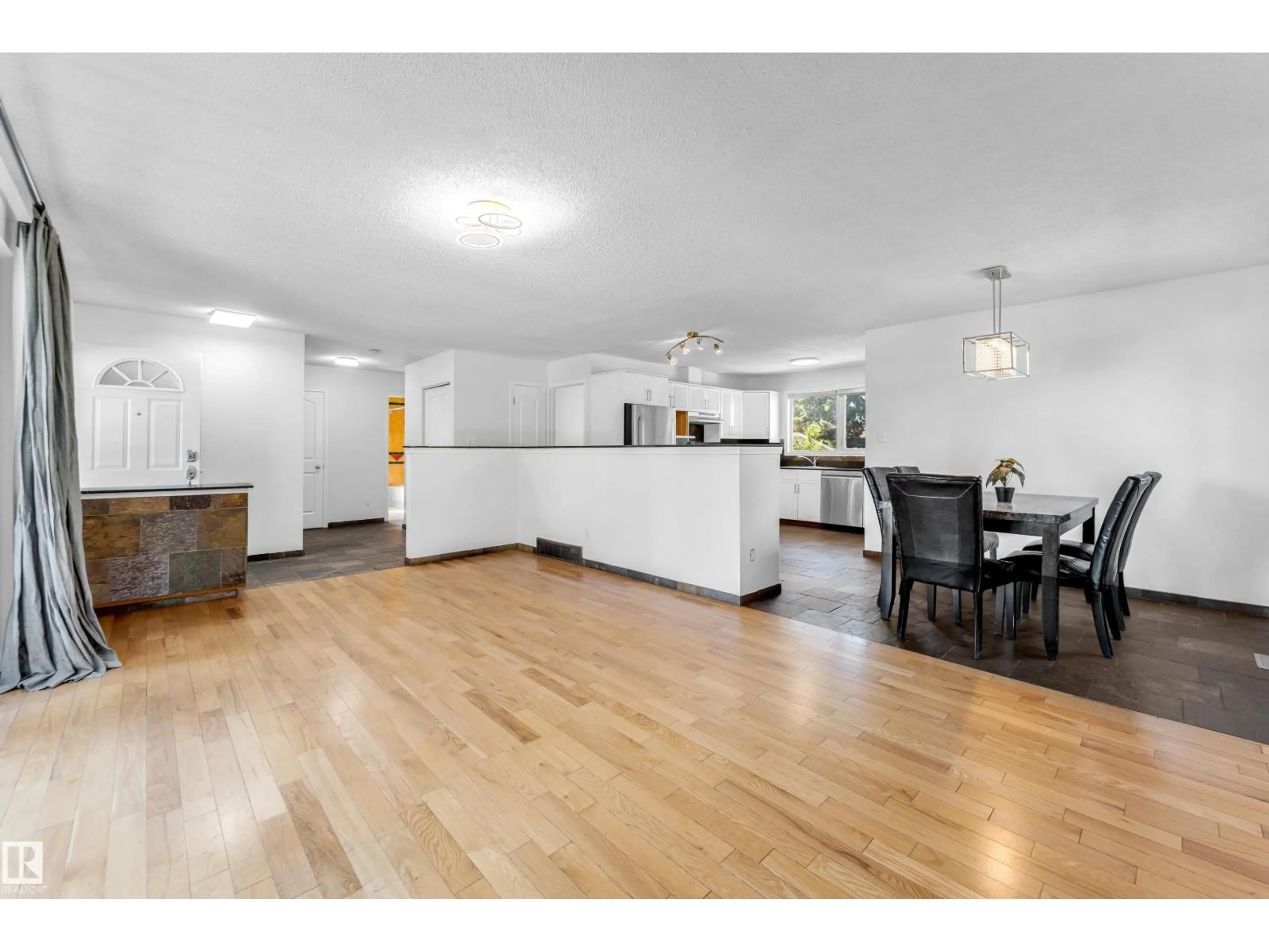 Open concept kitchen, wood/laminate floor for 4240 86 ST, Edmonton Alberta T6K1C4