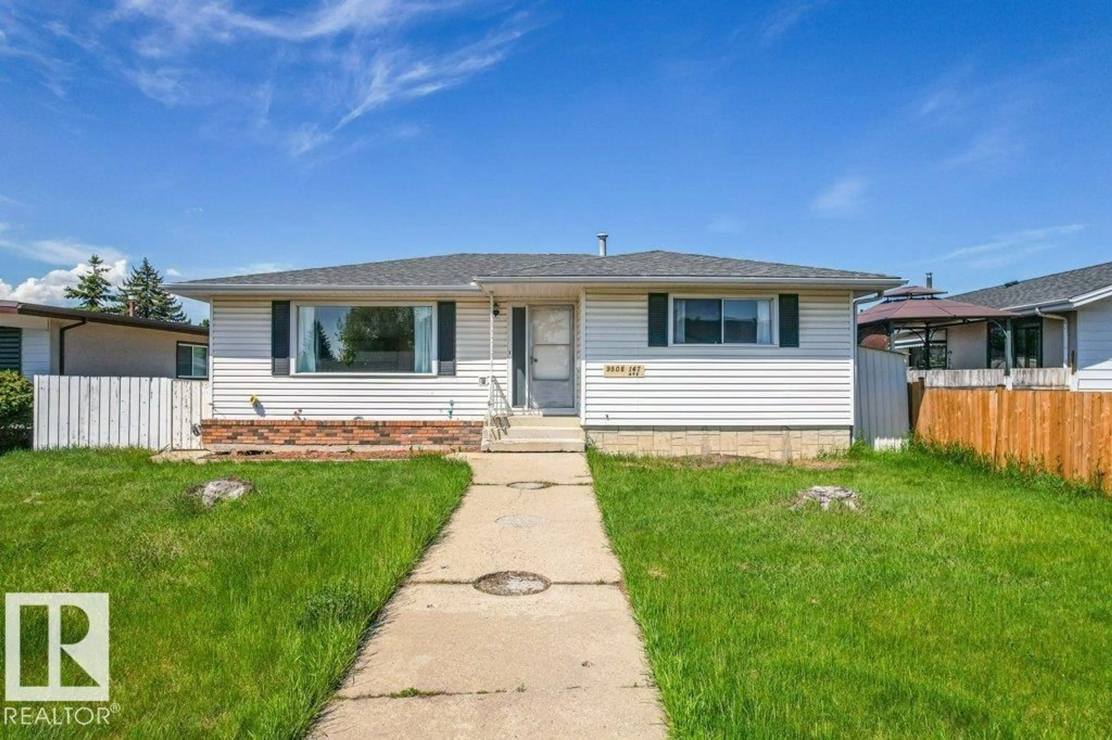Home with vinyl exterior material, street for NW - 9508 147 AV, Edmonton Alberta T5E2K6