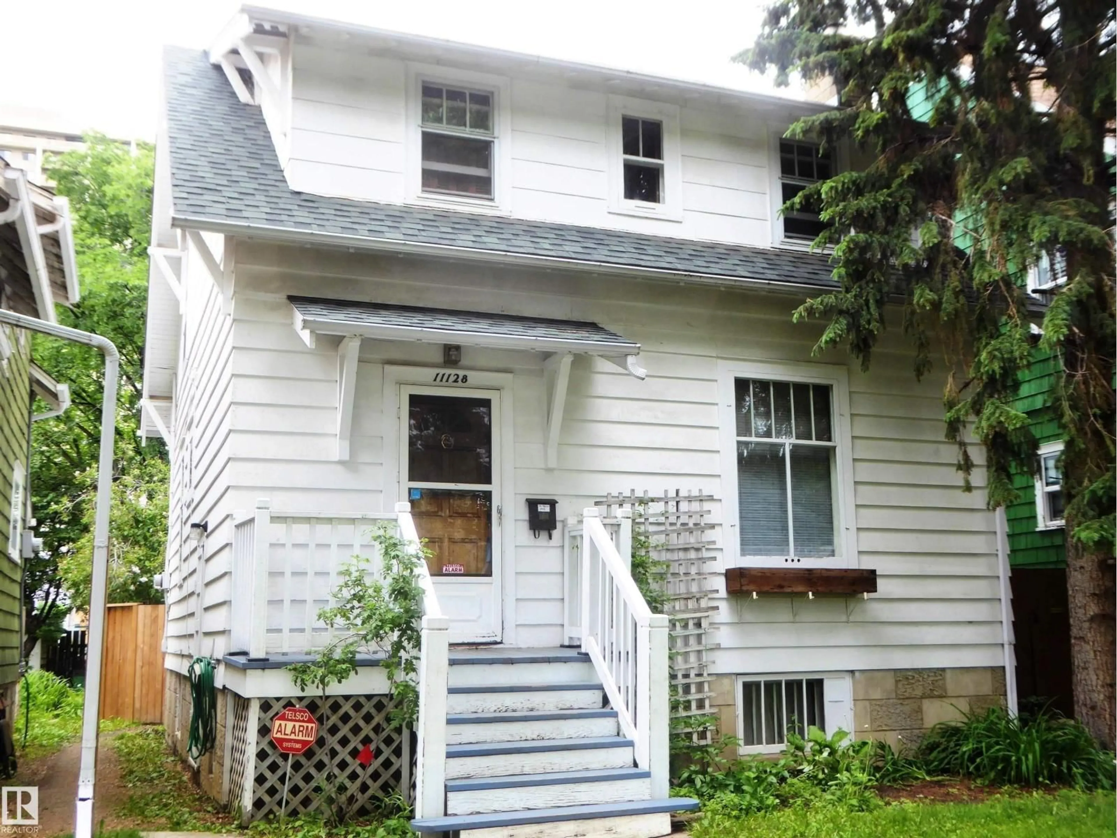 Home with vinyl exterior material, street for 11128 81 AV, Edmonton Alberta T6G0S5