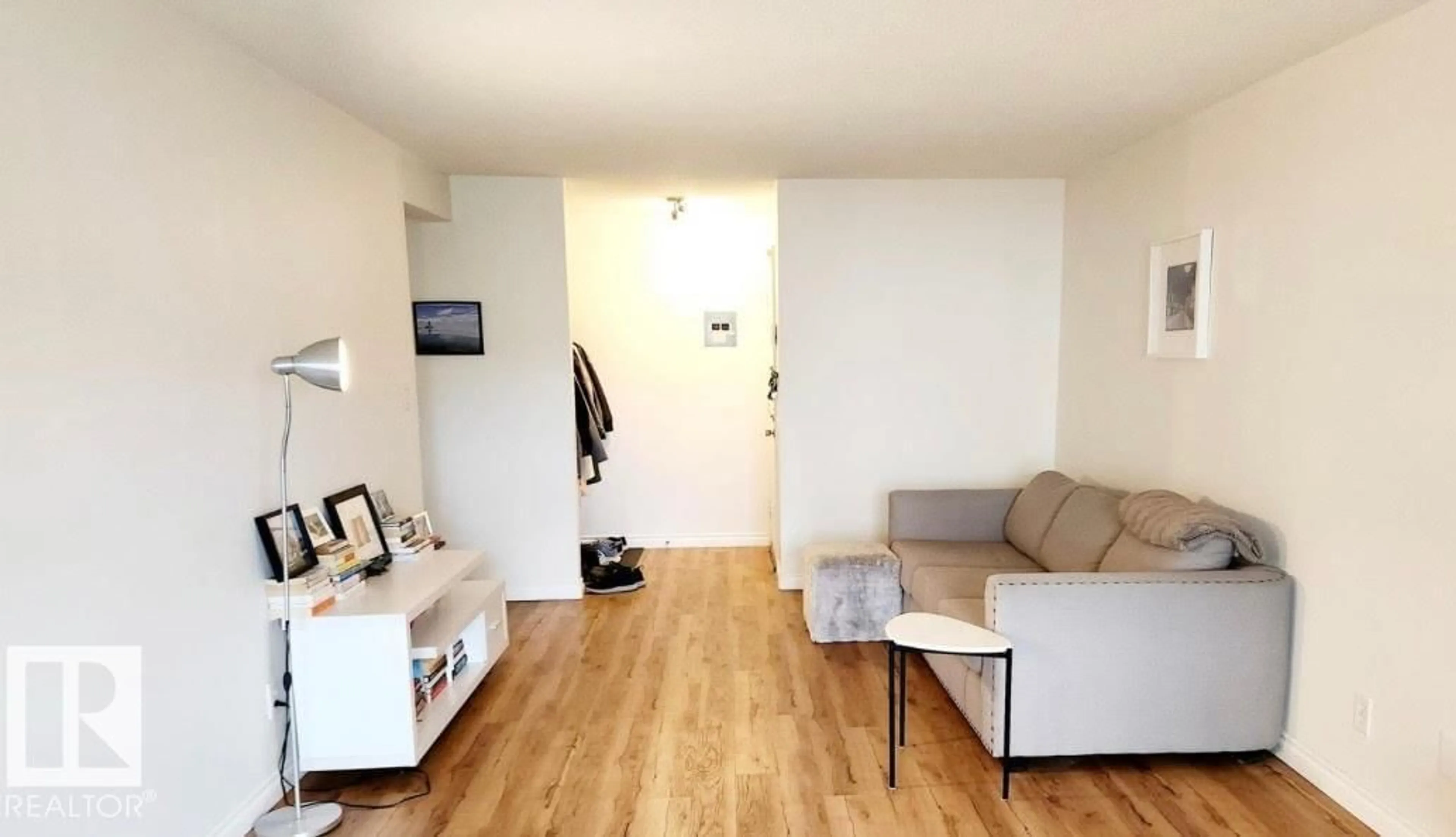 Living room with furniture, wood/laminate floor for 10835 114 ST, Edmonton Alberta T5H3K3