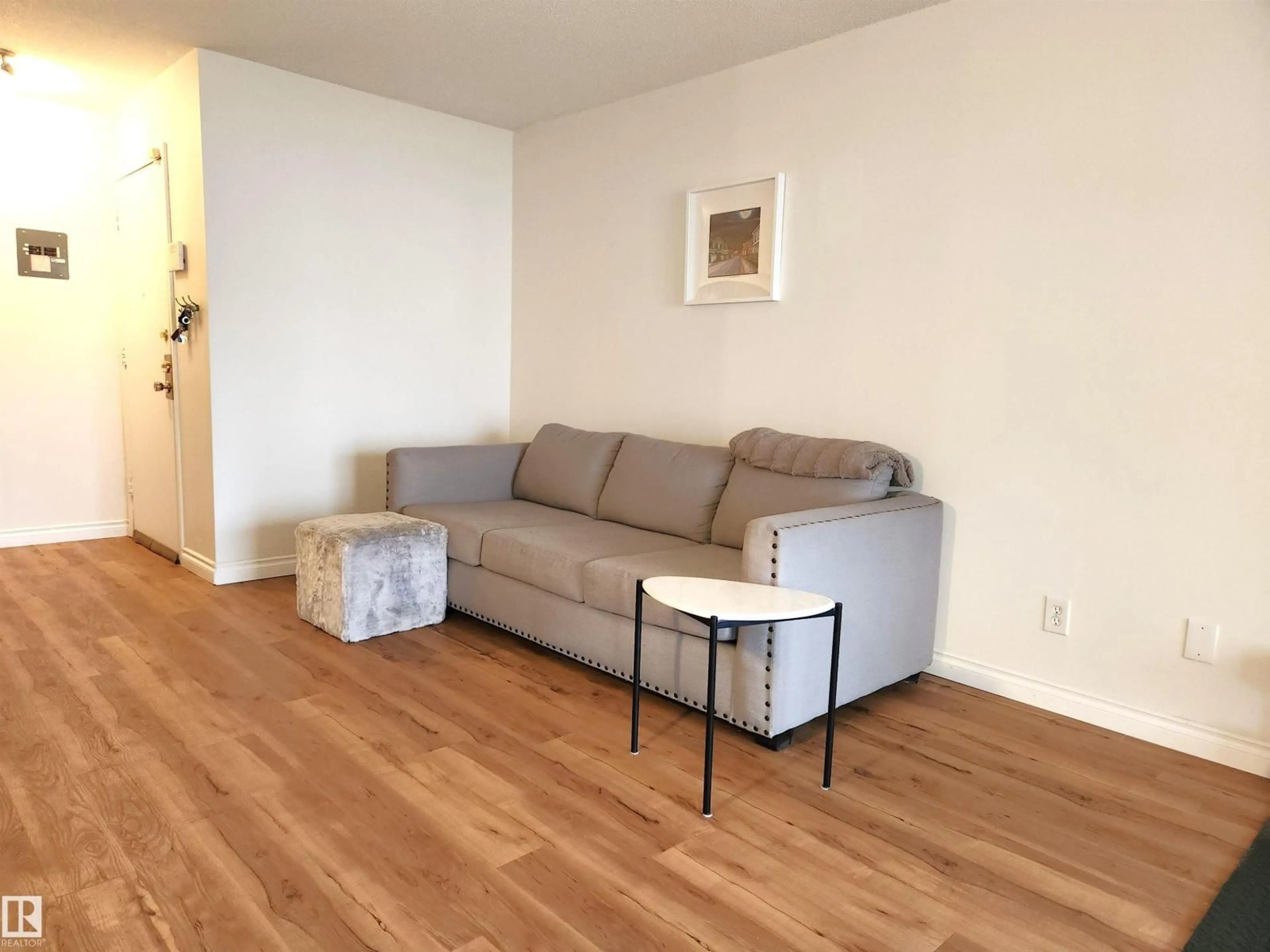 Living room with furniture, wood/laminate floor for 10835 114 ST, Edmonton Alberta T5H3K3