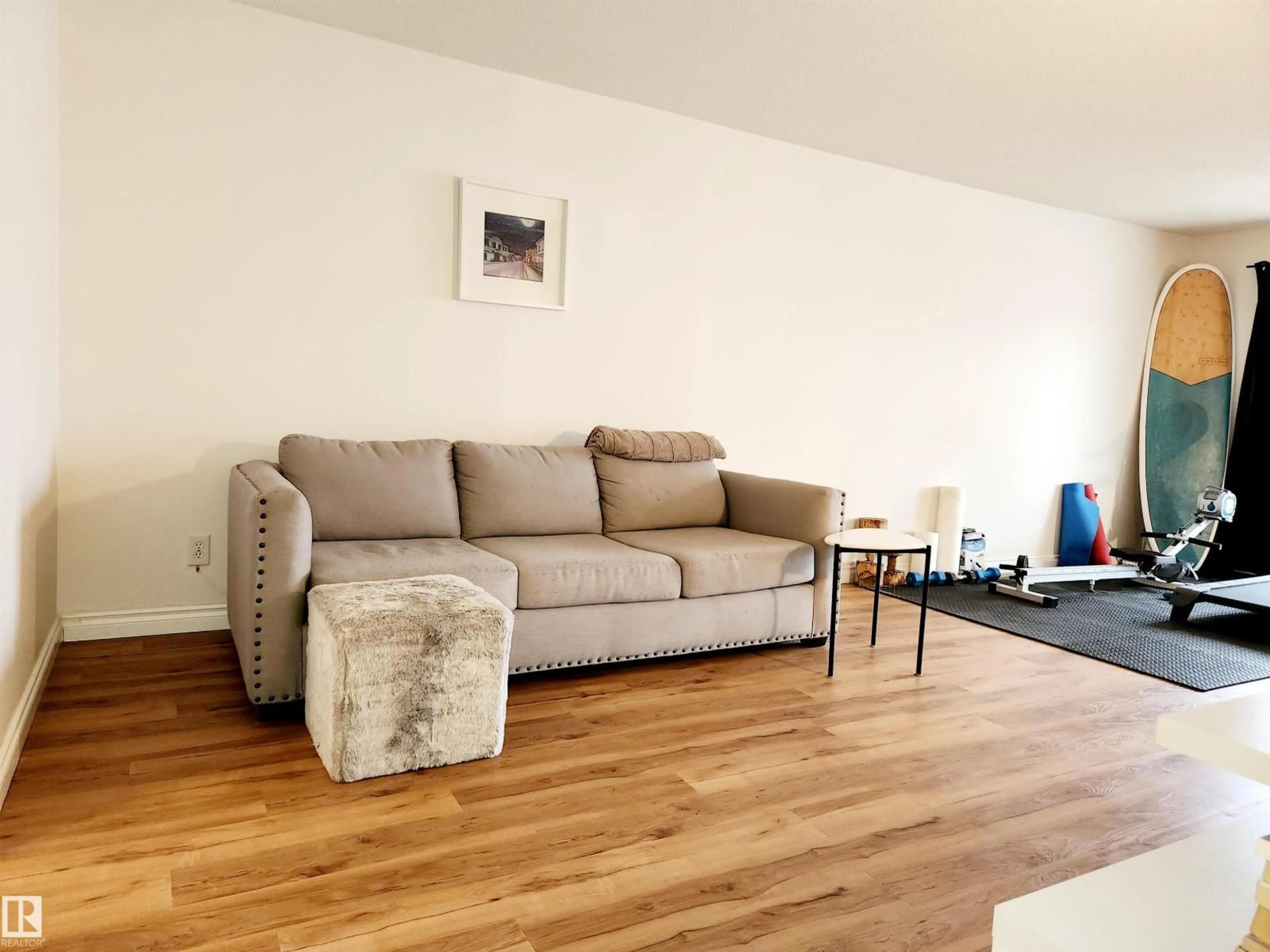 Living room with furniture, wood/laminate floor for 10835 114 ST, Edmonton Alberta T5H3K3