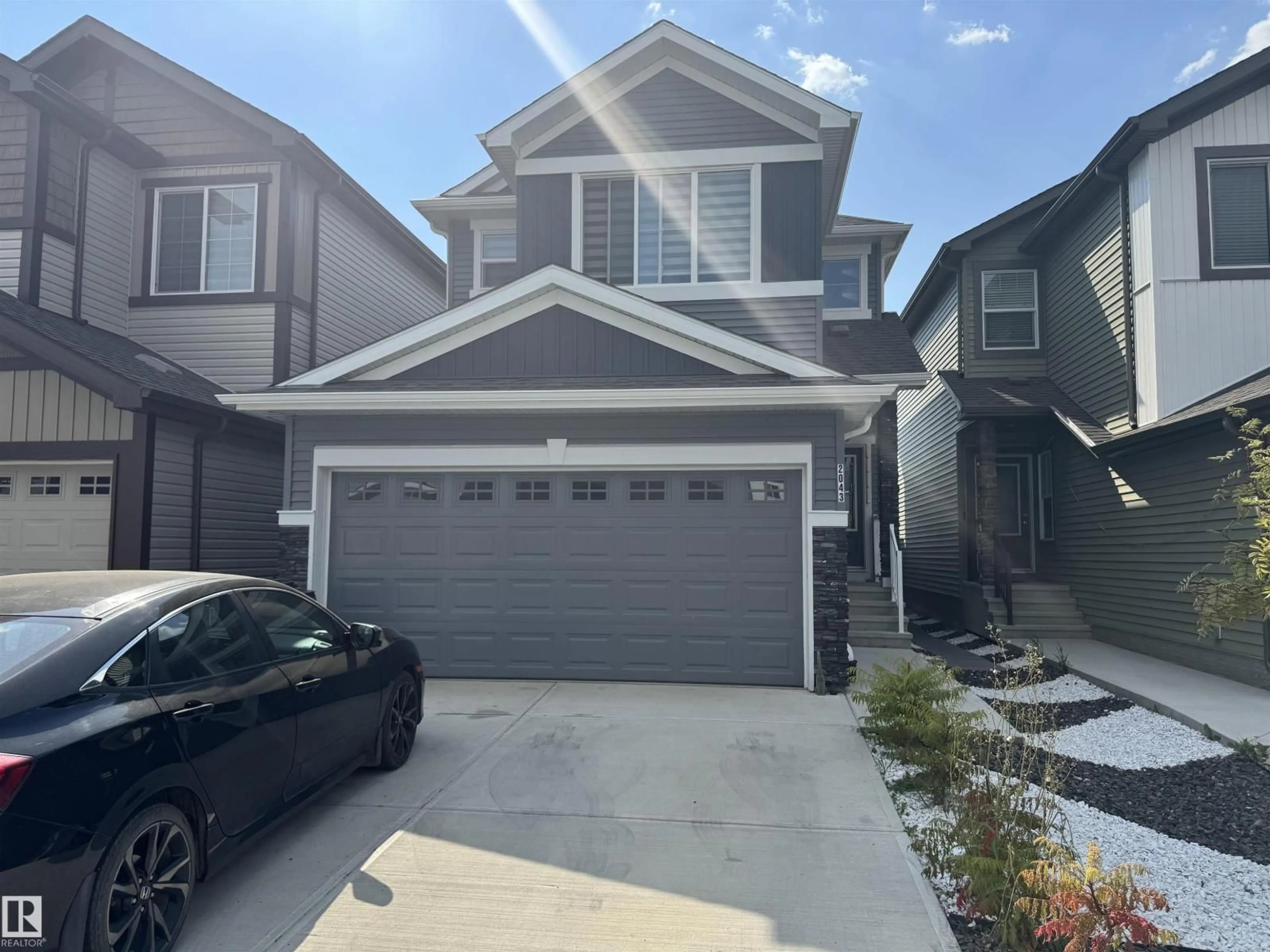 Home with vinyl exterior material, street for 2043 13 AV, Edmonton Alberta T6T2R8