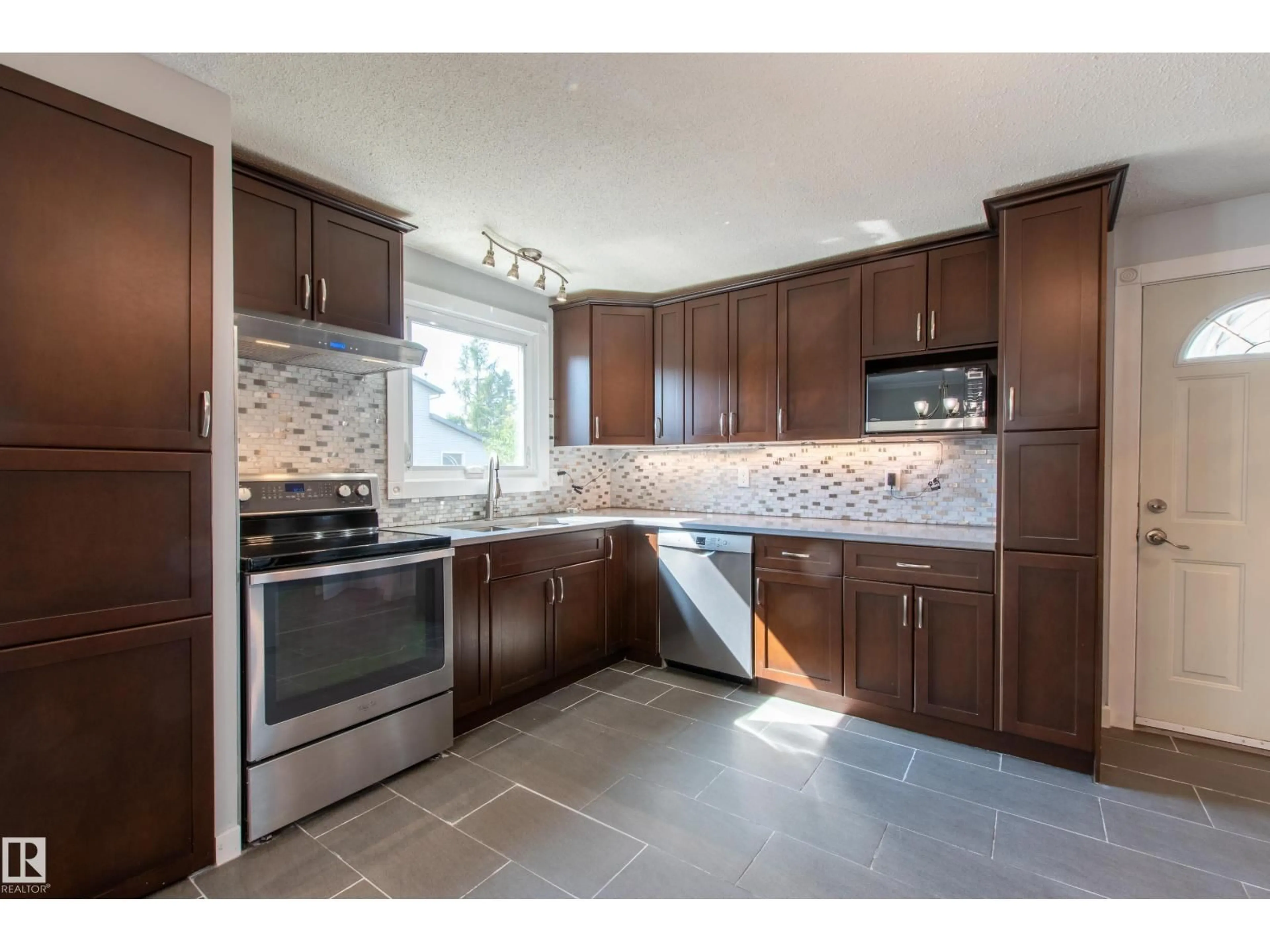 Open concept kitchen, ceramic/tile floor for 18115 76 AV, Edmonton Alberta T5T2E9