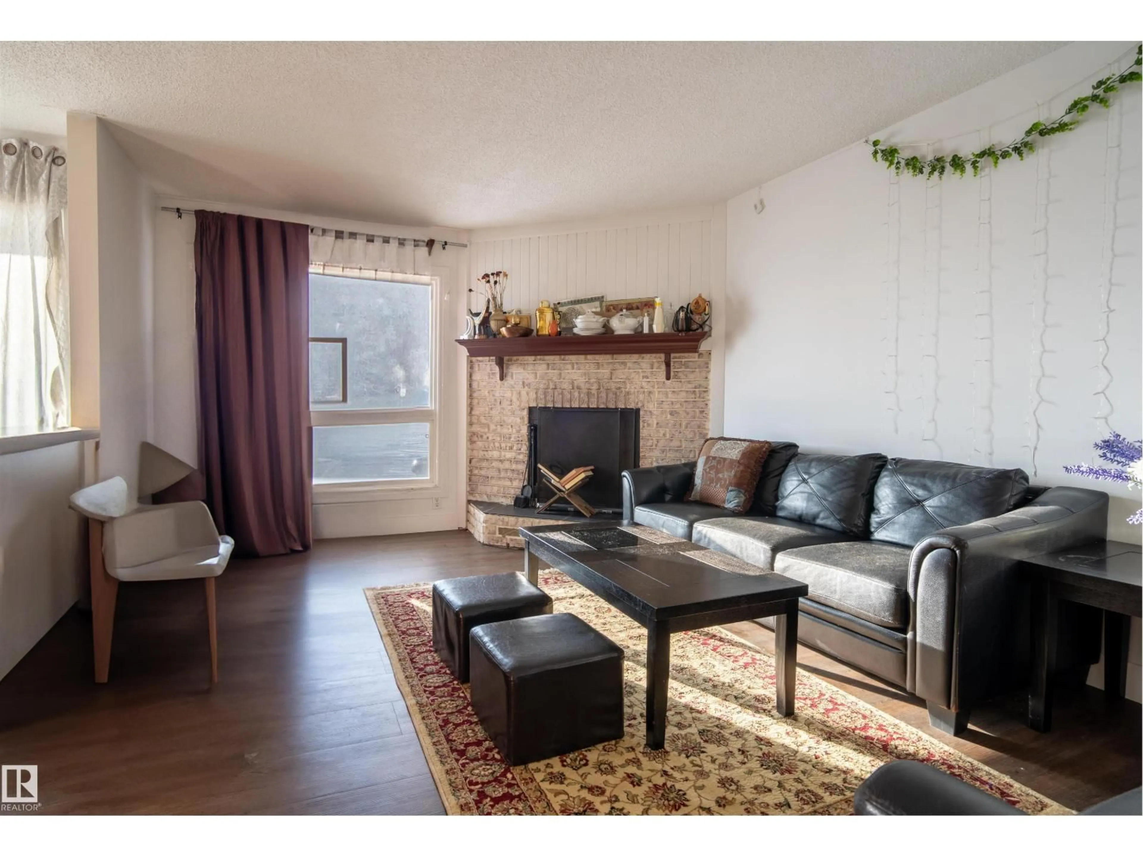 Living room with furniture, wood/laminate floor for 210 WARWICK RD, Edmonton Alberta T5X4P8