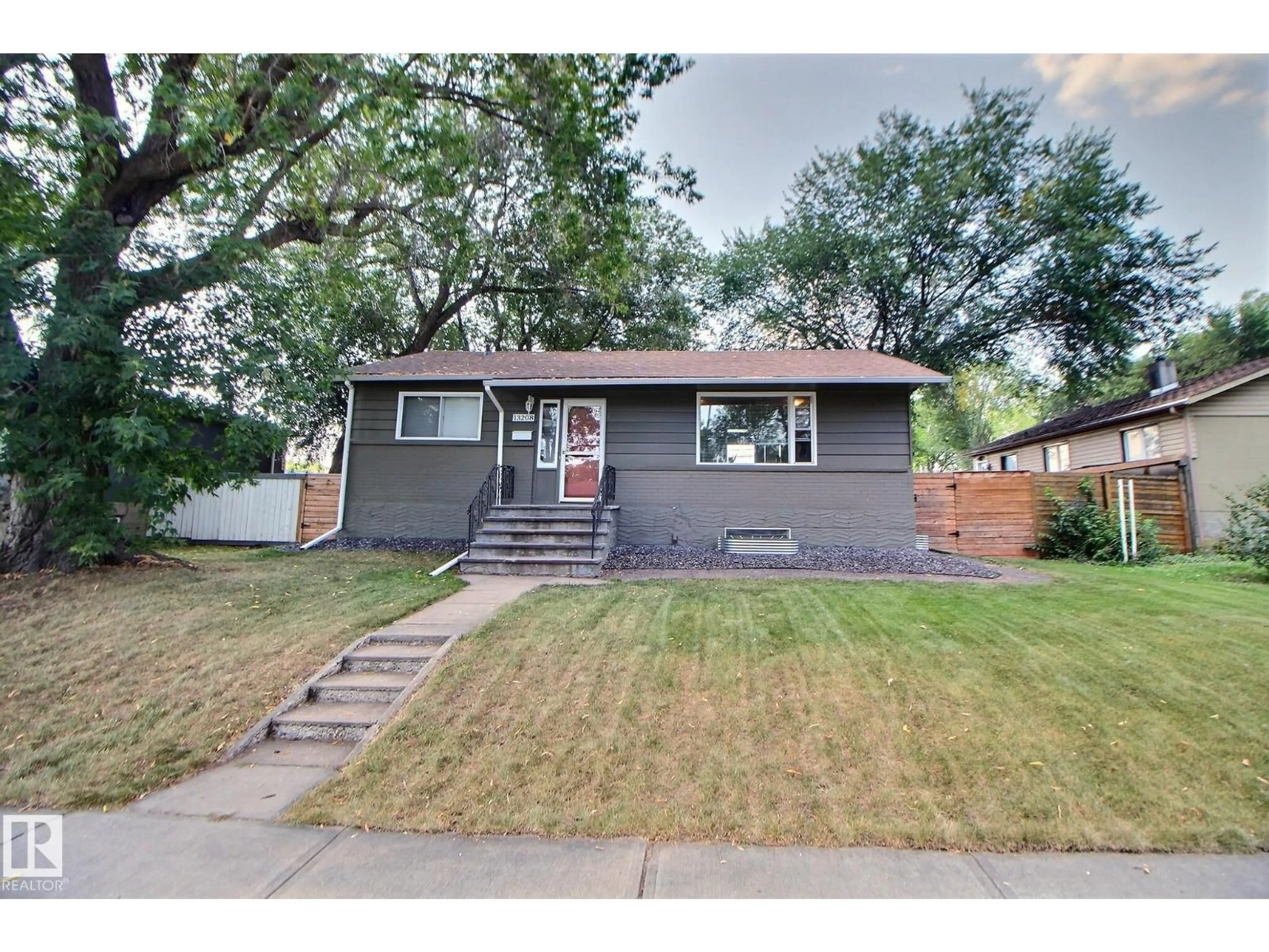Home with vinyl exterior material, street for 13208 SHERBROOKE AV, Edmonton Alberta T5G4G3