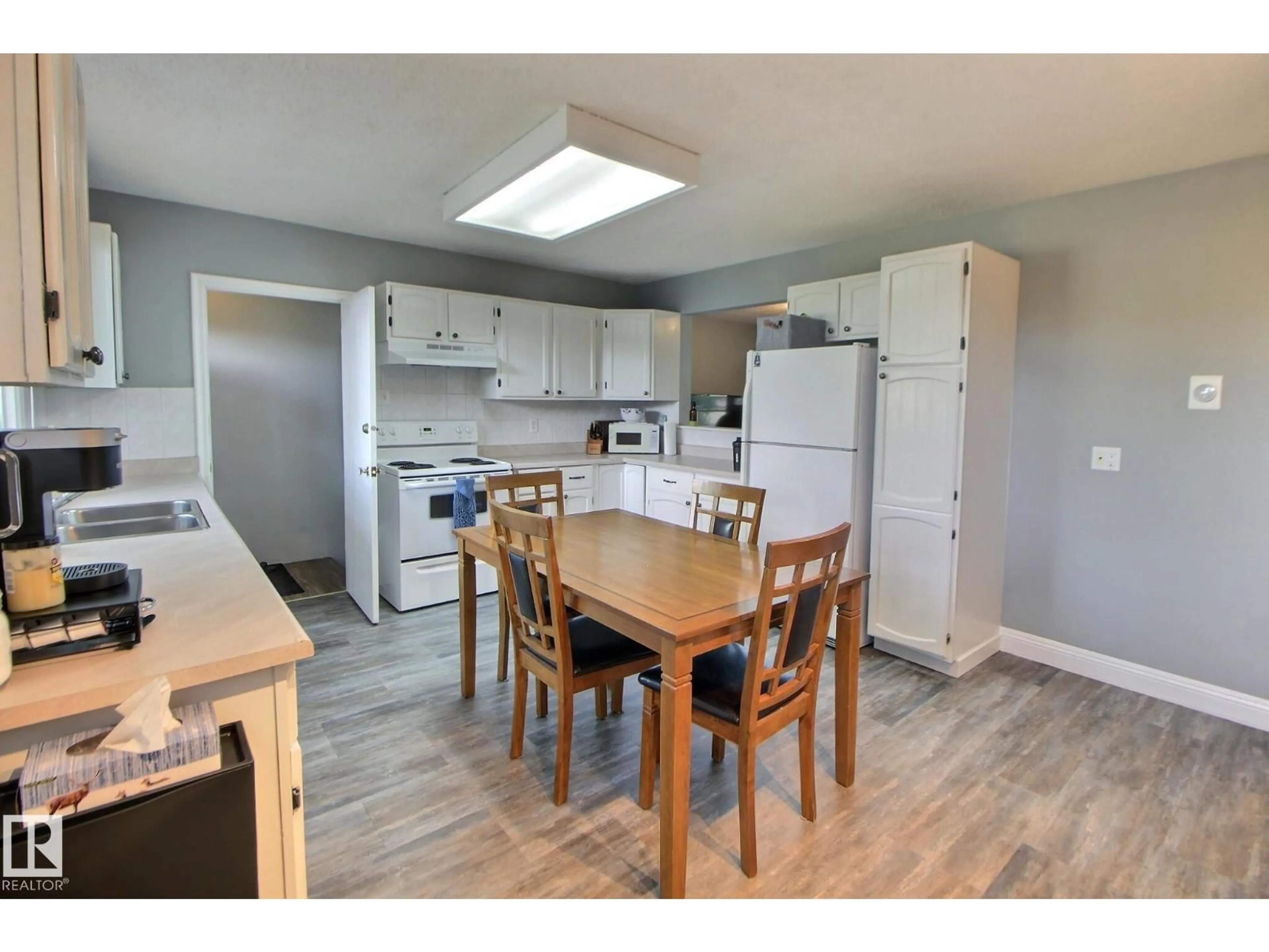 Open concept kitchen, wood/laminate floor for 13208 SHERBROOKE AV, Edmonton Alberta T5G4G3