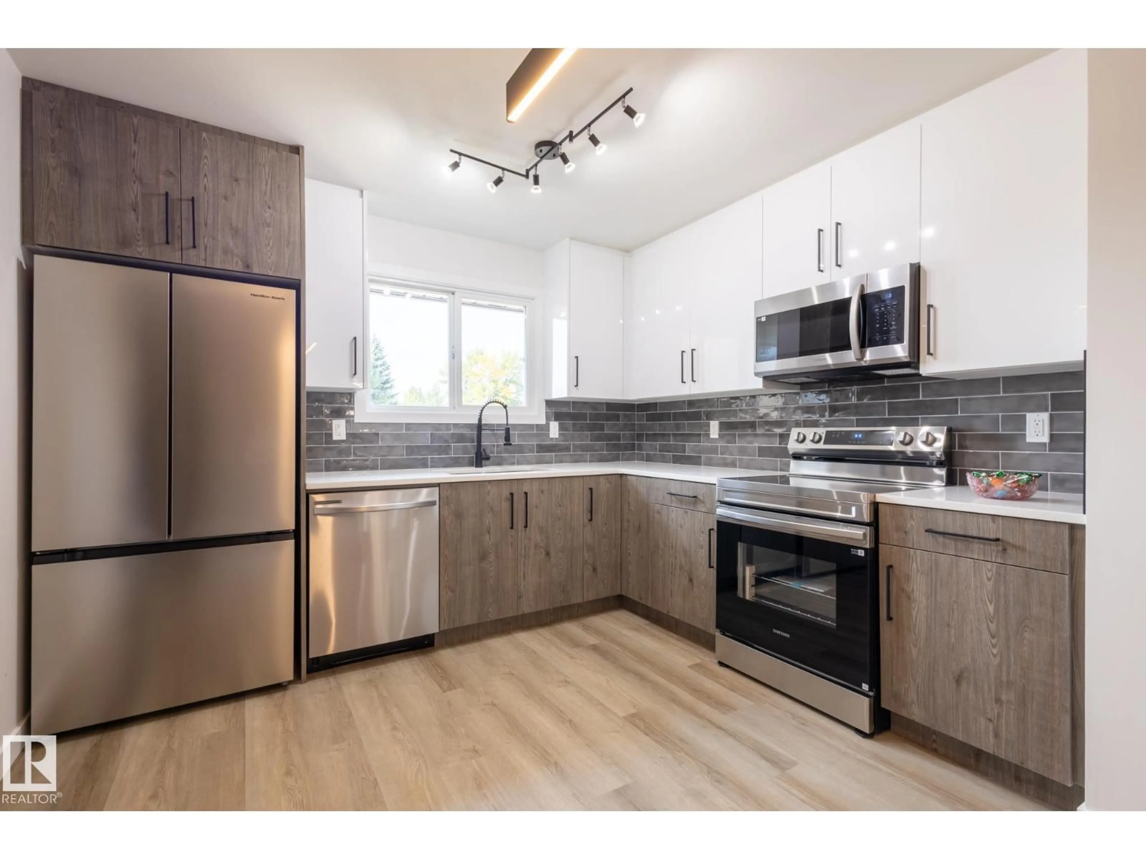 Open concept kitchen, wood/laminate floor for 14618 25 ST, Edmonton Alberta T5Y1X4