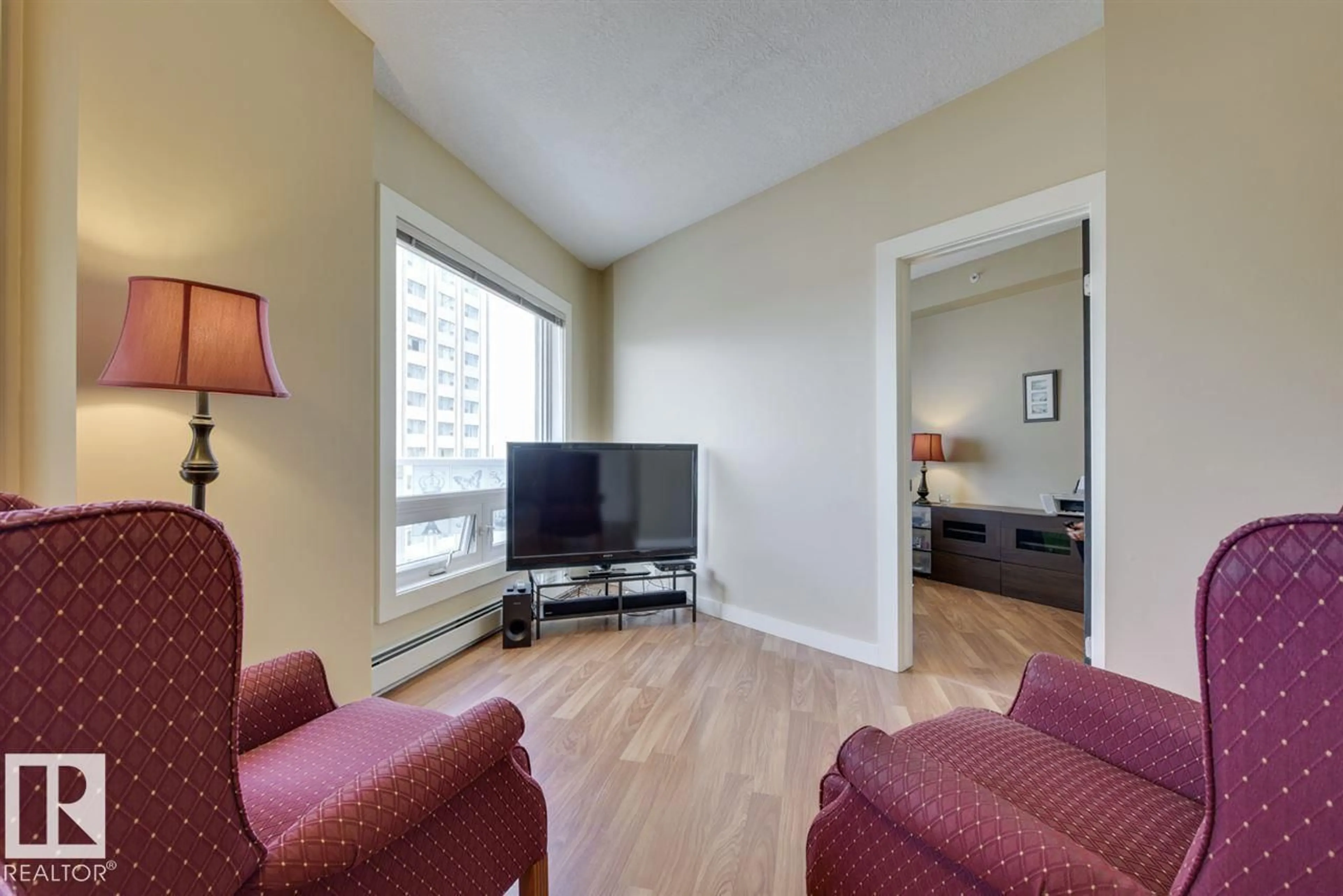 Living room with furniture, wood/laminate floor for 10136 - 906 104 ST, Edmonton Alberta T5J0B5