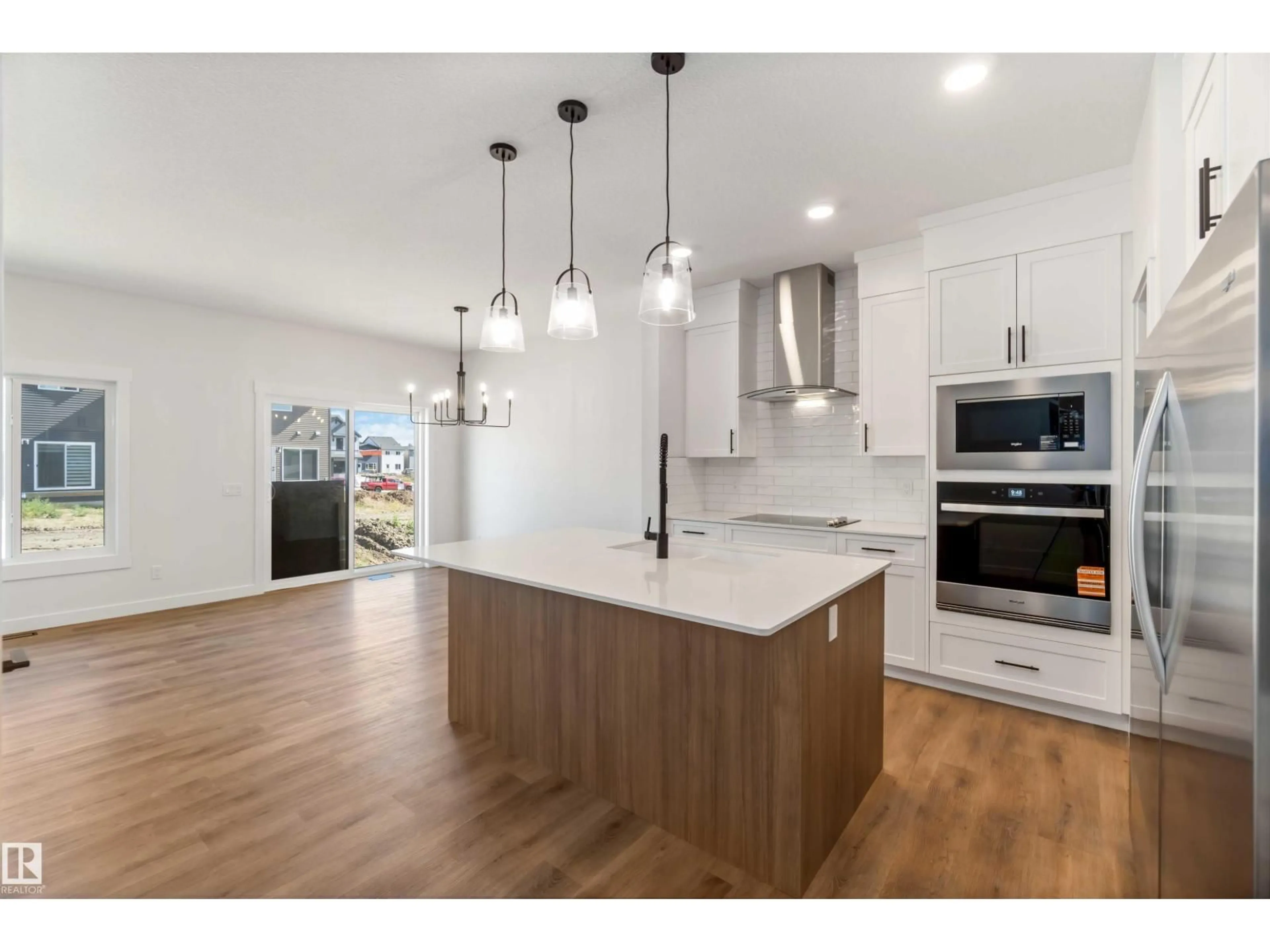 Open concept kitchen, wood/laminate floor for 8980 ELVES LO, Edmonton Alberta T6M3G3