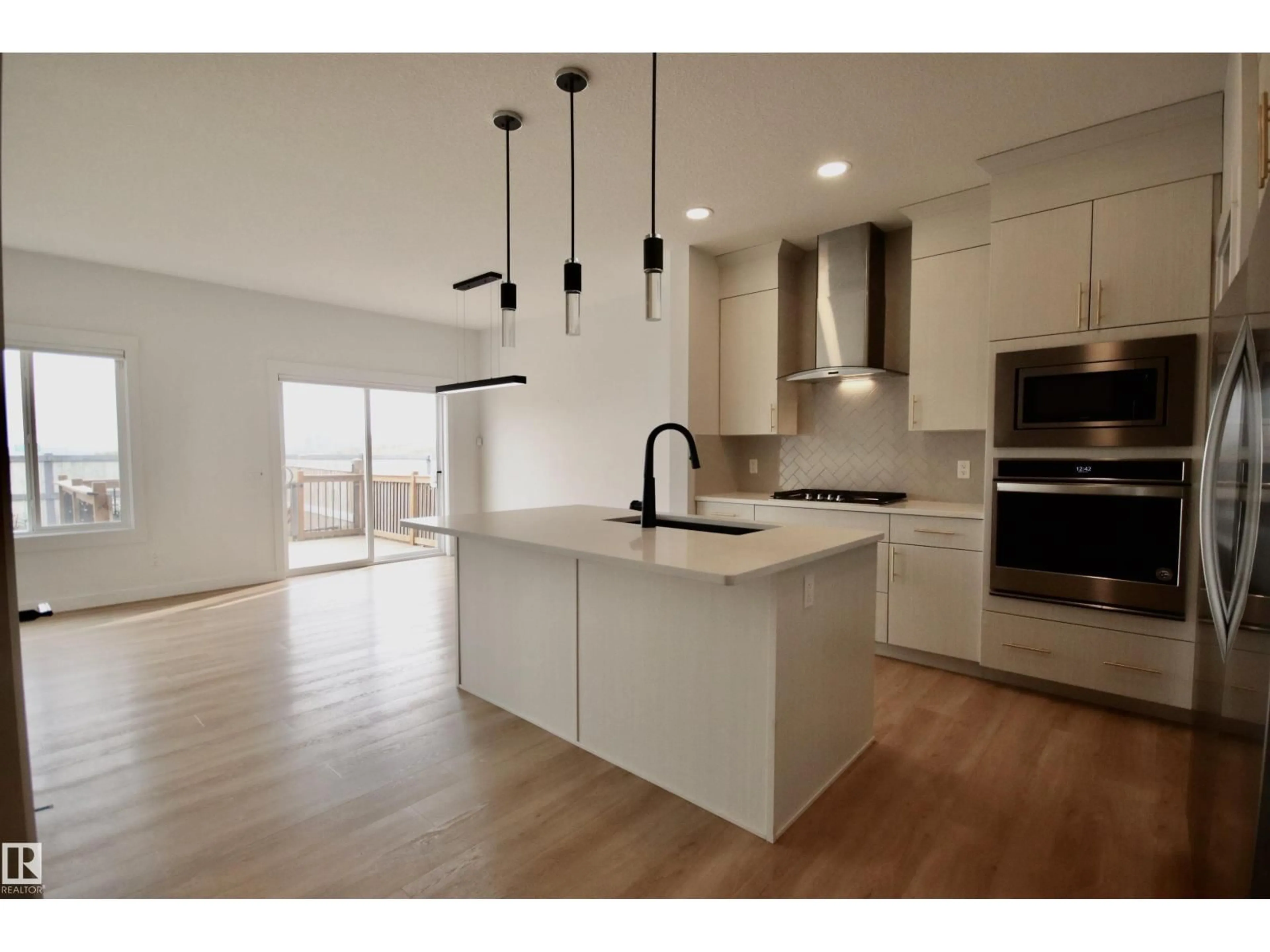 Open concept kitchen, wood/laminate floor for NW - 9981 205A ST, Edmonton Alberta T5T7N4