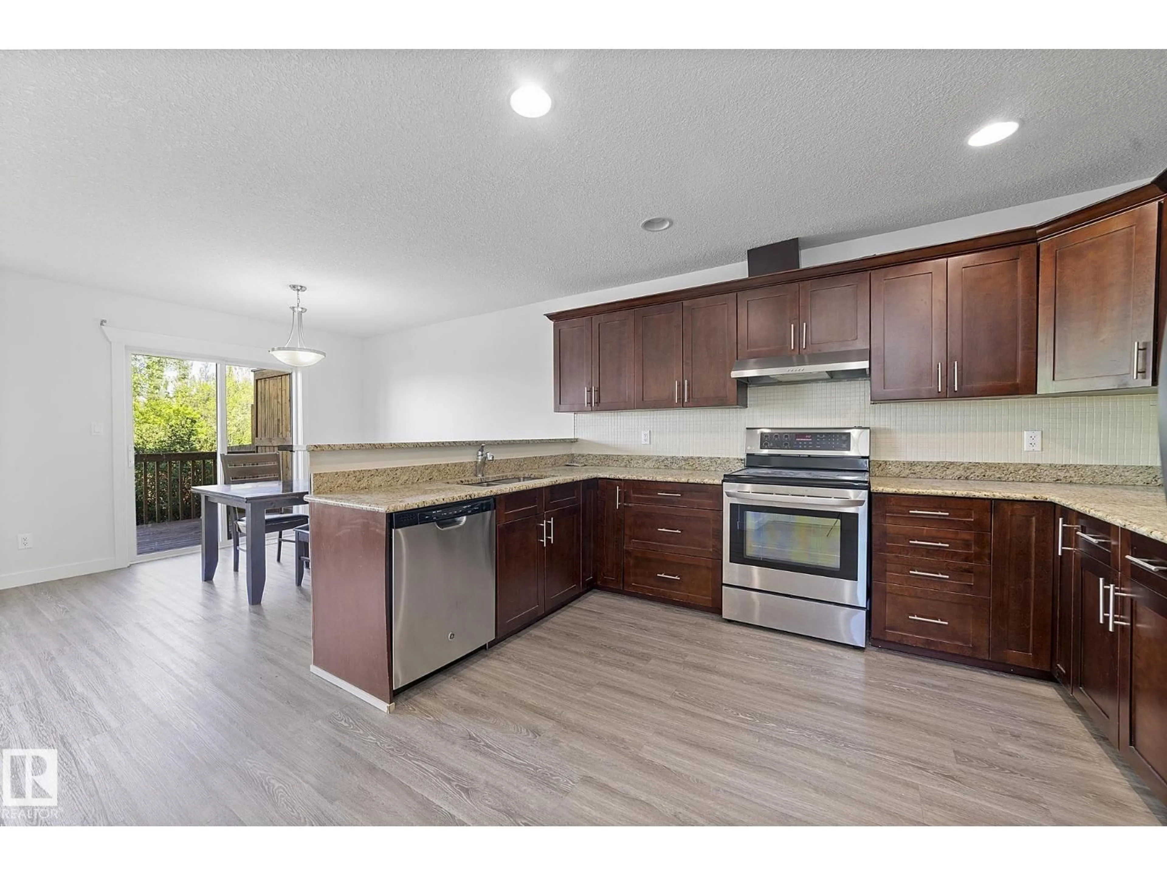 Open concept kitchen, wood/laminate floor for 3210 67 ST, Beaumont Alberta T4X0W7