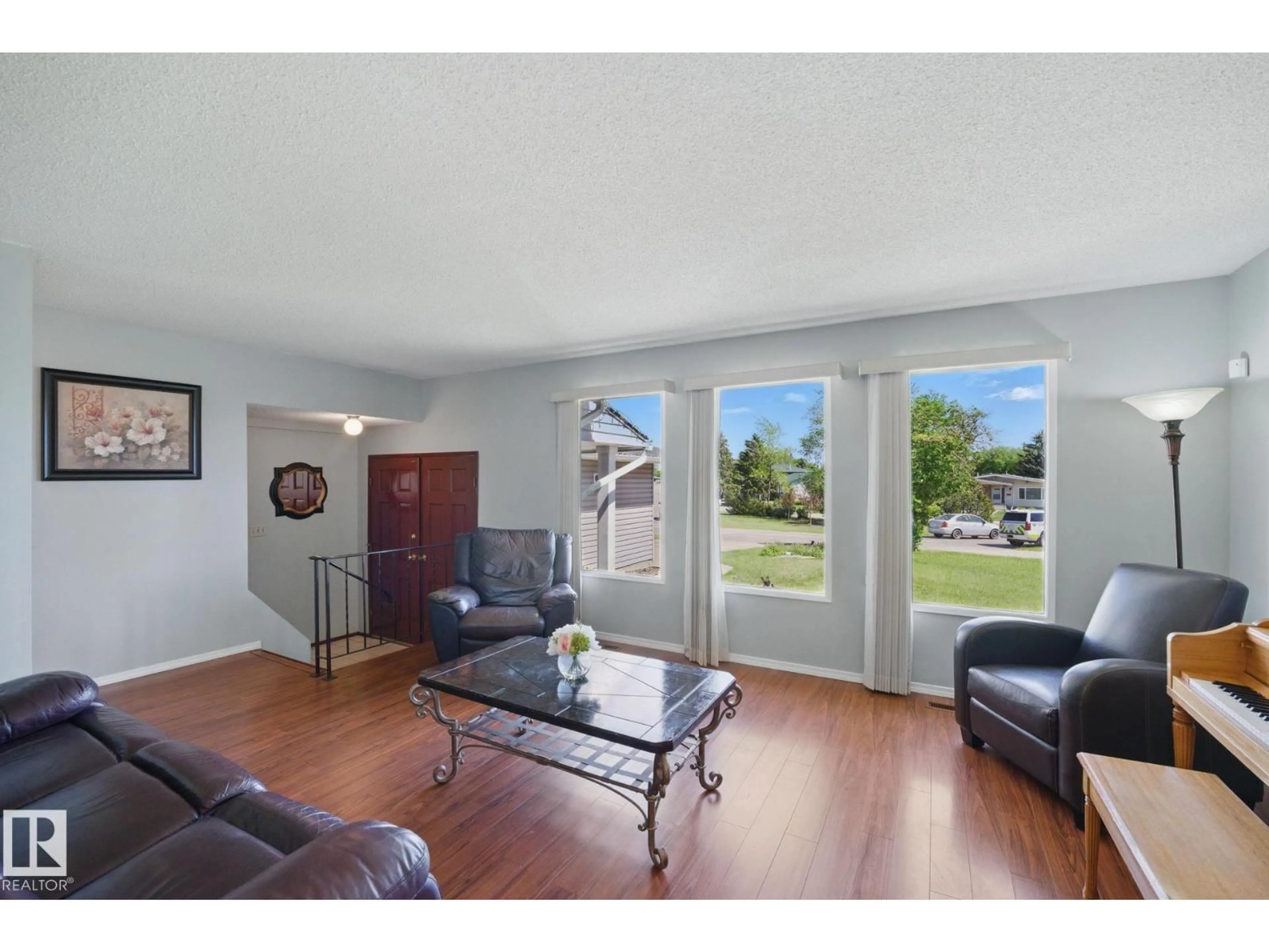 Living room with furniture, wood/laminate floor for 4336 74 ST, Edmonton Alberta T6K0W2