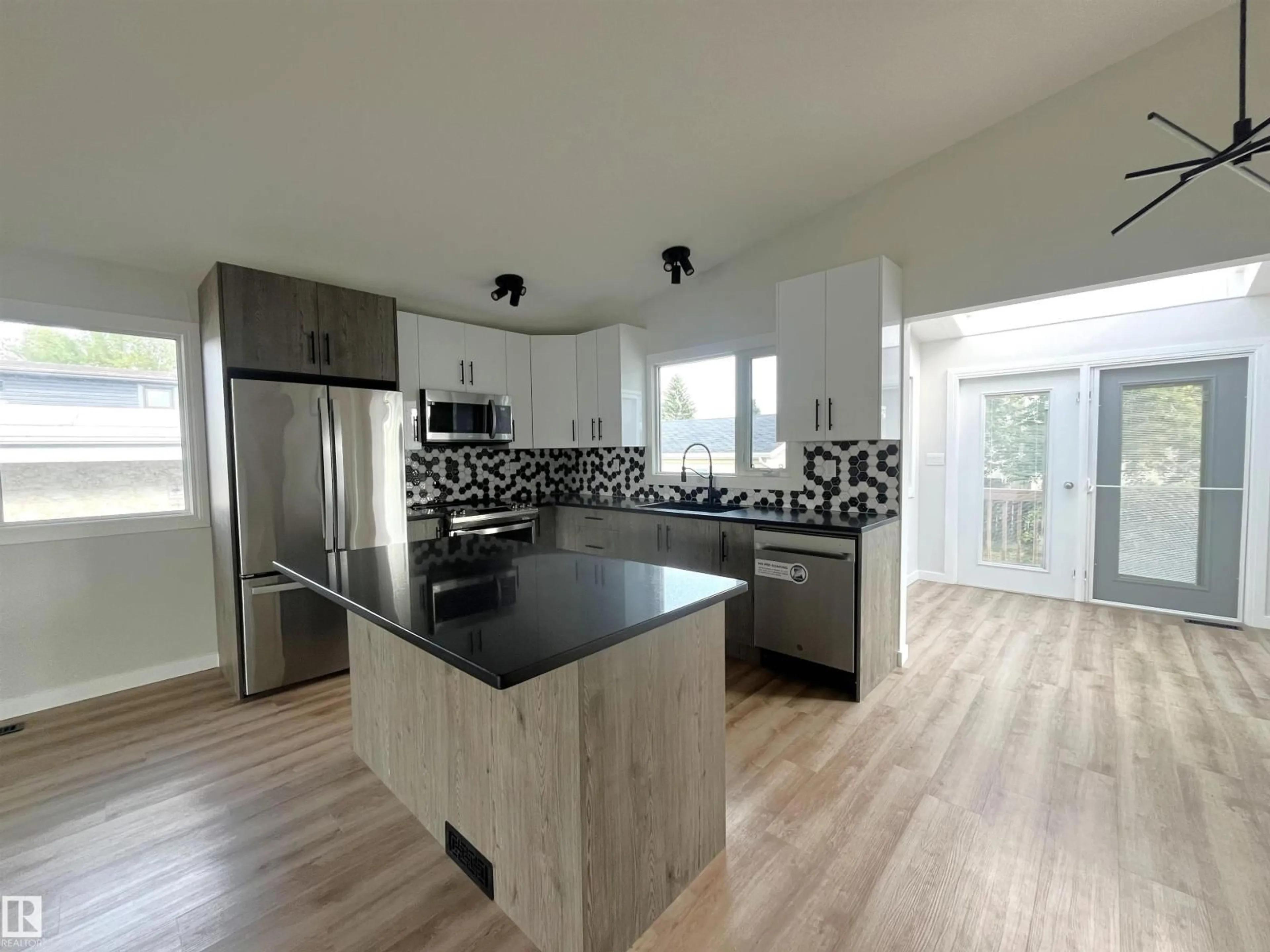 Open concept kitchen, wood/laminate floor for 16307 112 ST, Edmonton Alberta T5X2B2