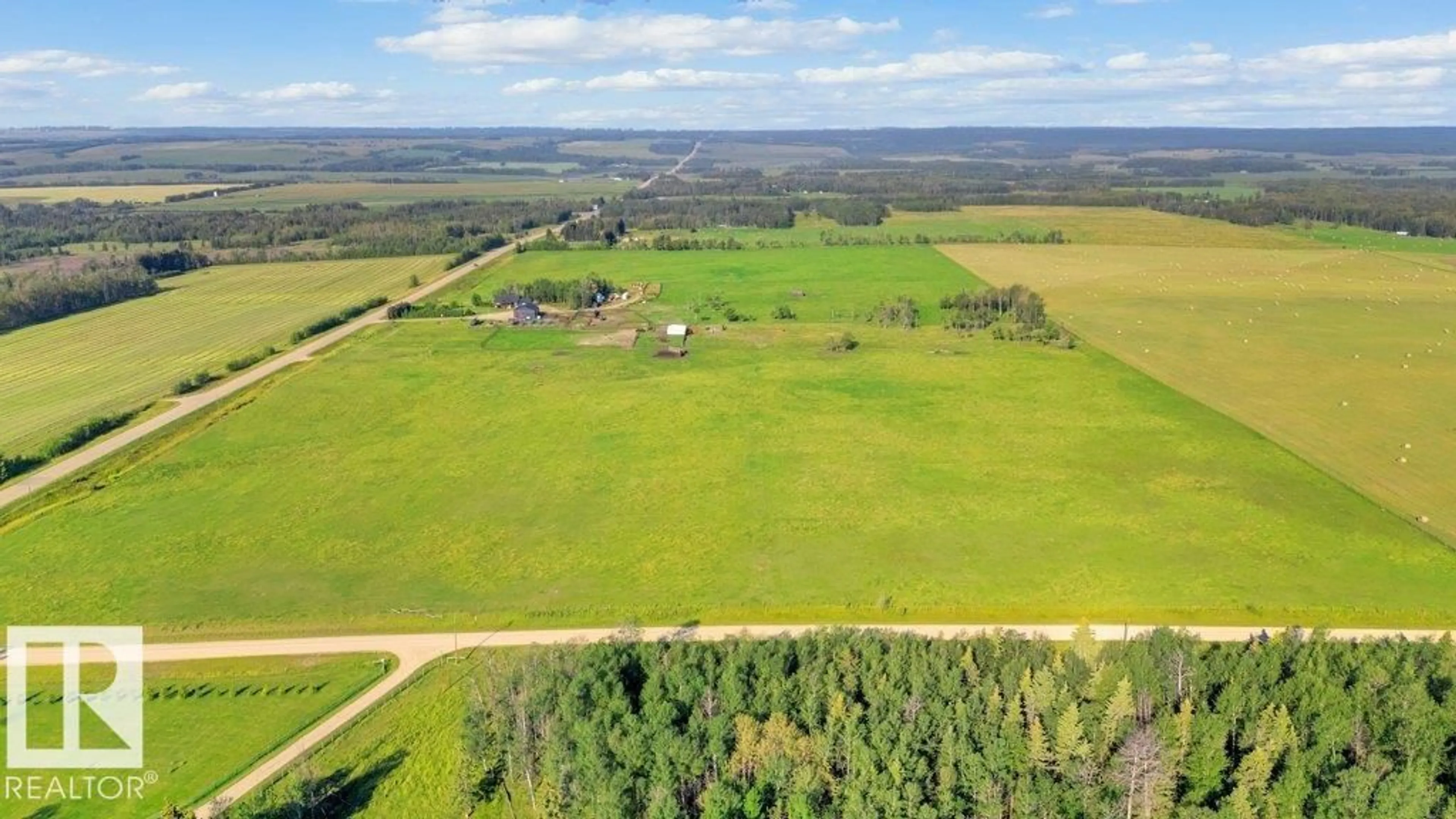 A pic from outside/outdoor area/front of a property/back of a property/a pic from drone, unknown for 32022 HWY 611, Rural Ponoka County Alberta T0C0M0