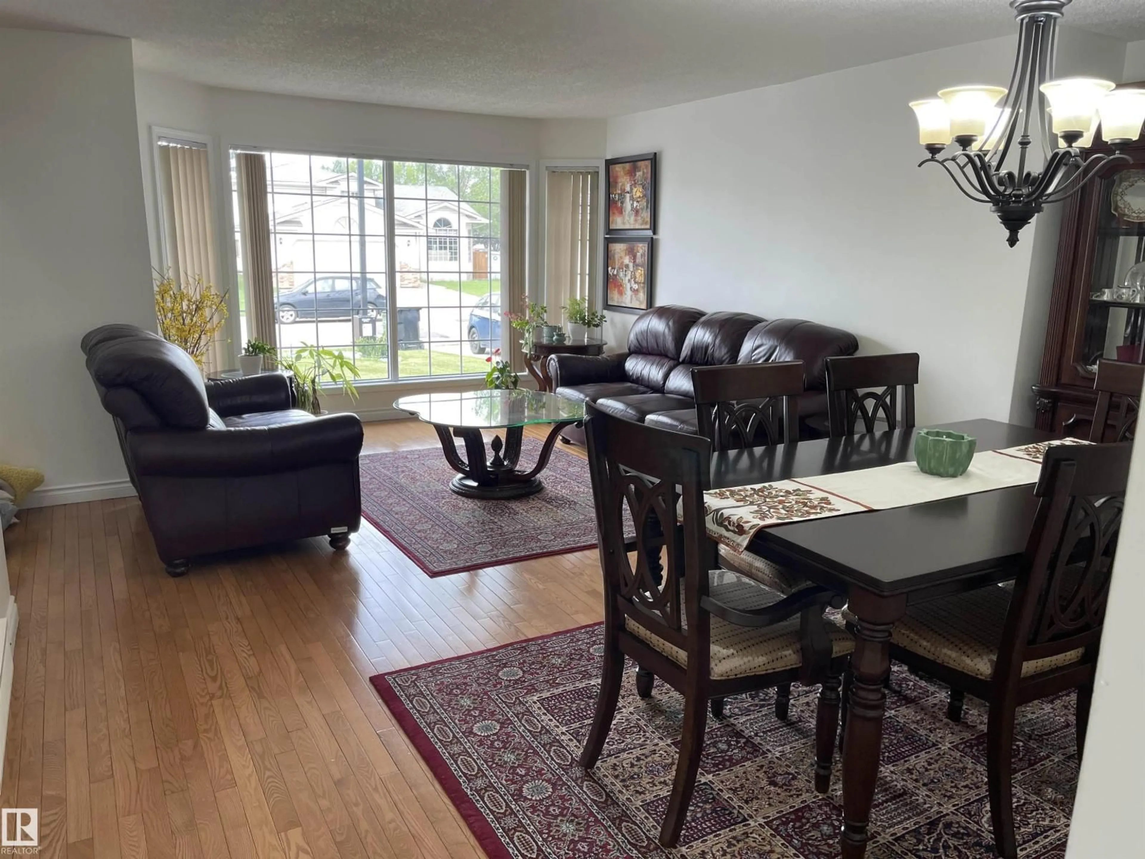 Living room with furniture, wood/laminate floor for 3155 36 AV, Edmonton Alberta T6T1H8