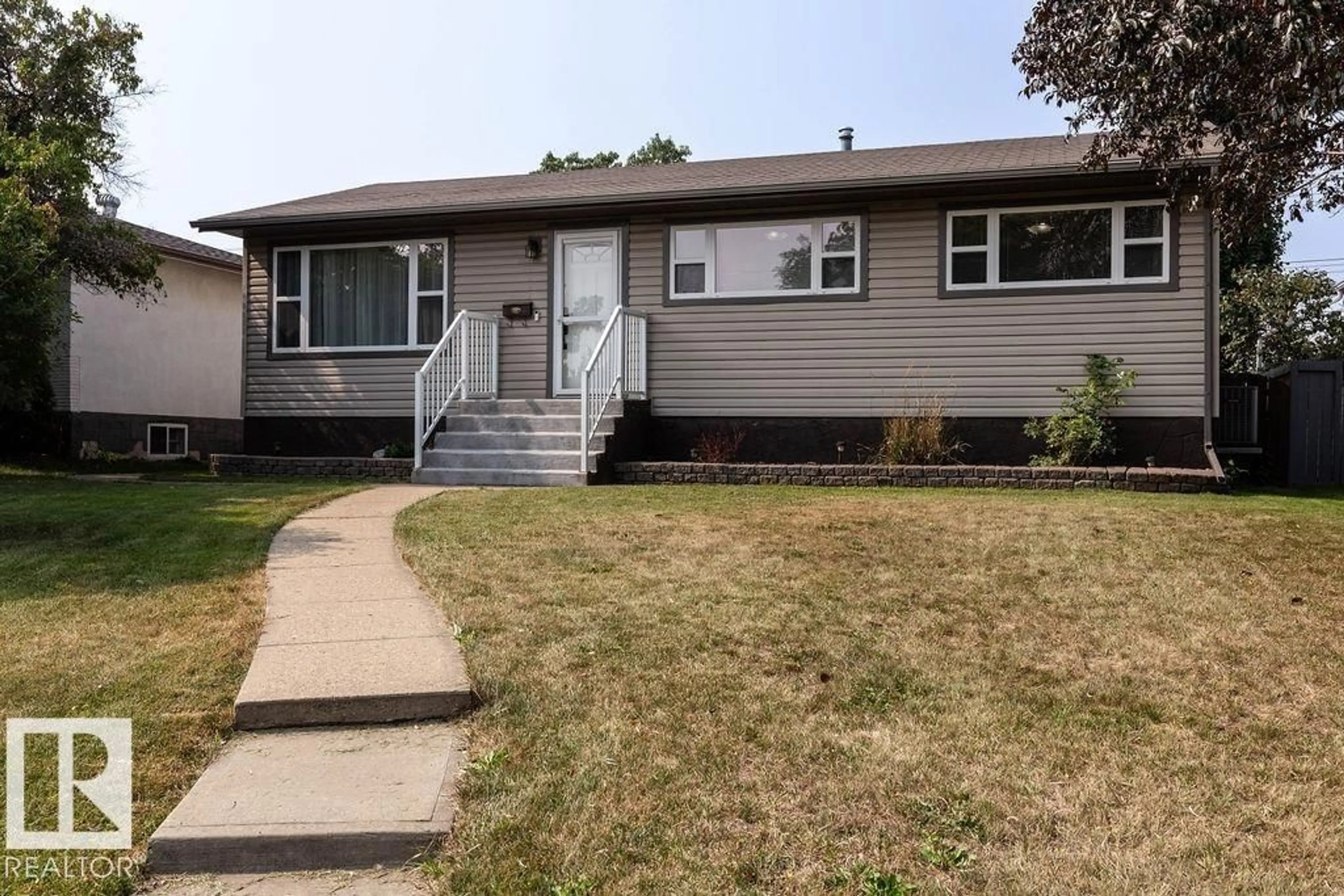 Home with vinyl exterior material, street for 8916 148 ST NW, Edmonton Alberta T5R1A1