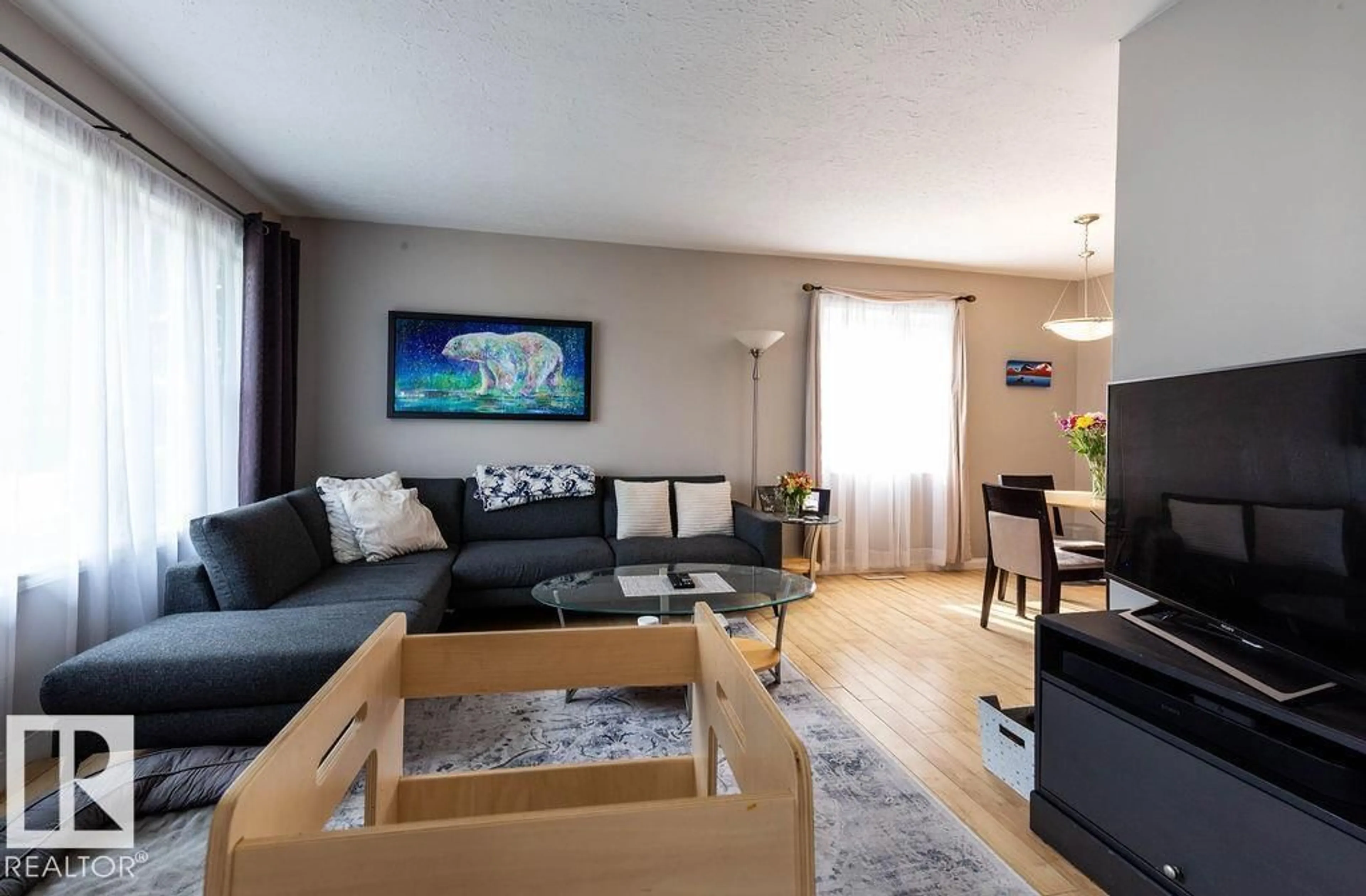 Living room with furniture, wood/laminate floor for 8916 148 ST NW, Edmonton Alberta T5R1A1