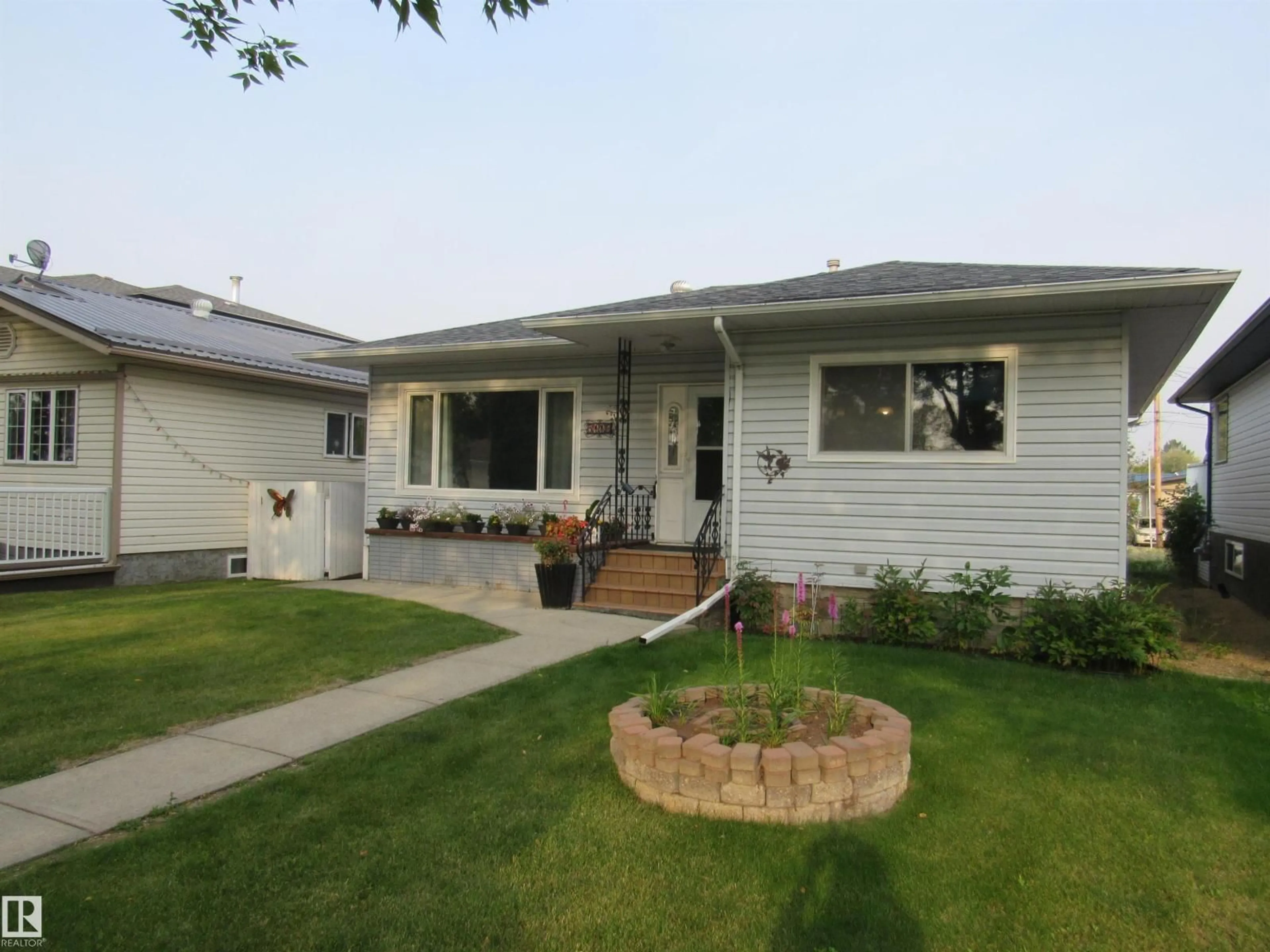 Home with vinyl exterior material, street for 5110 52ND STREET, Barrhead Alberta T7N1G1