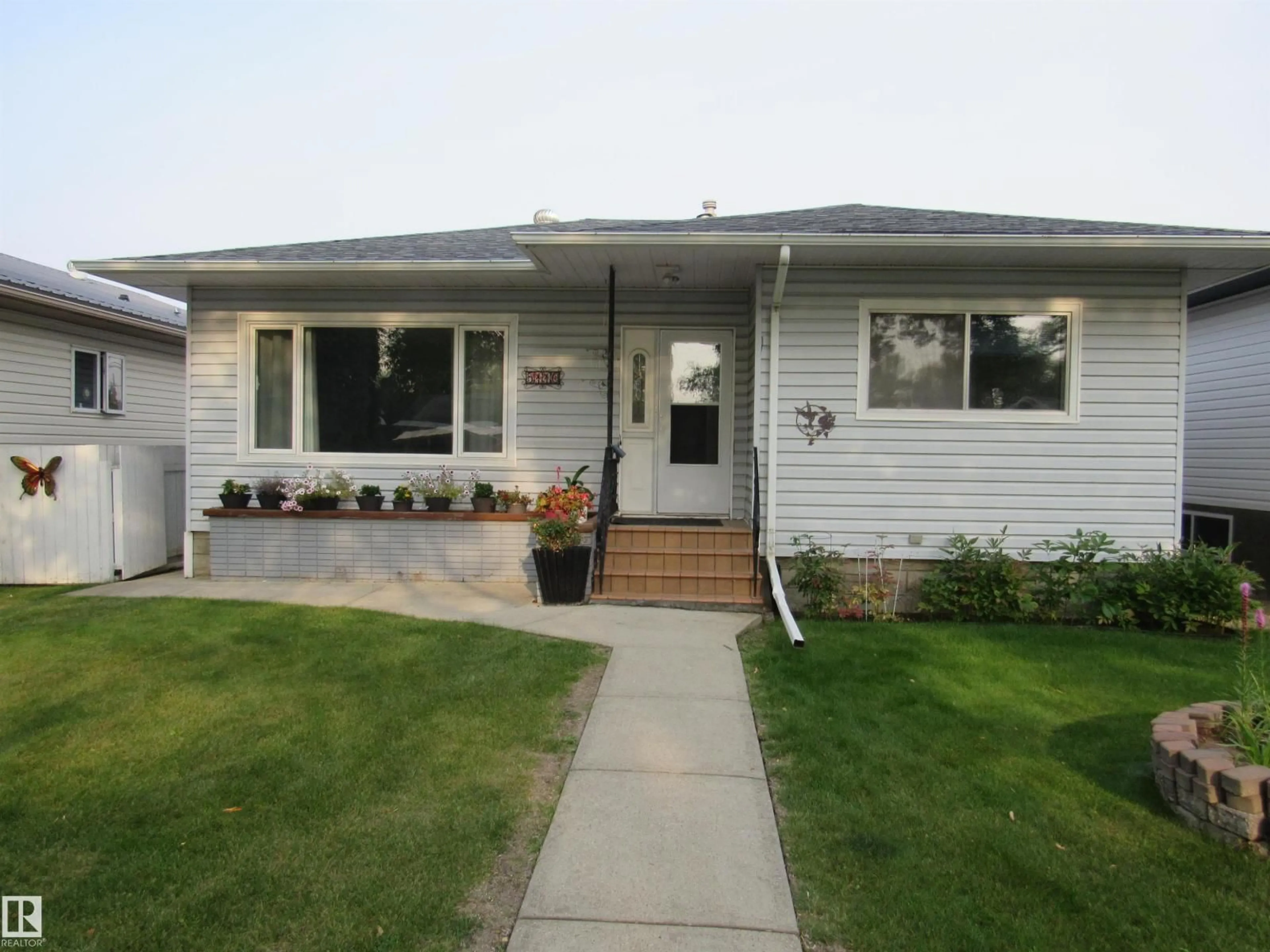 Home with vinyl exterior material, street for 5110 52ND STREET, Barrhead Alberta T7N1G1