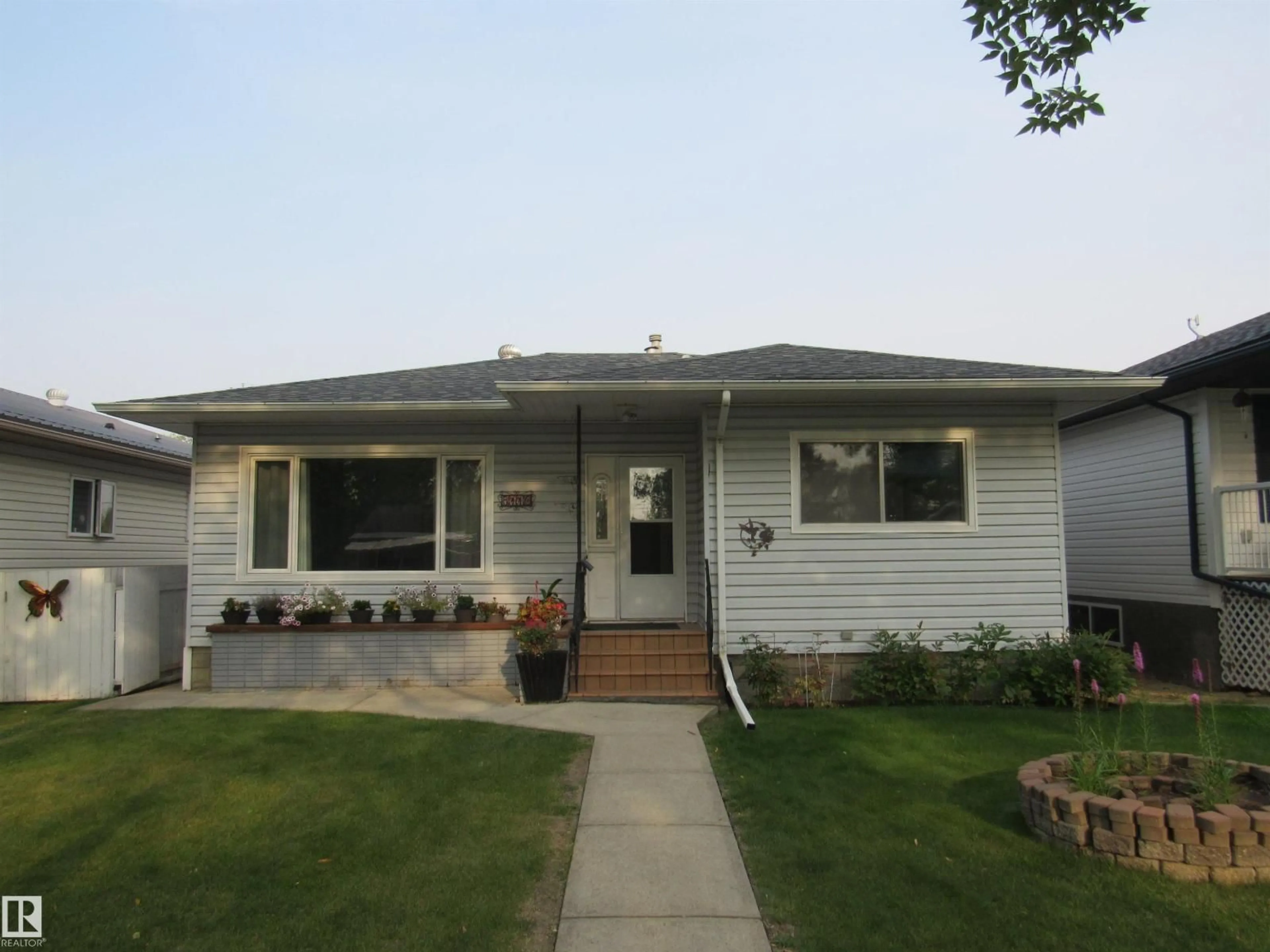 Home with vinyl exterior material, street for 5110 52ND STREET, Barrhead Alberta T7N1G1