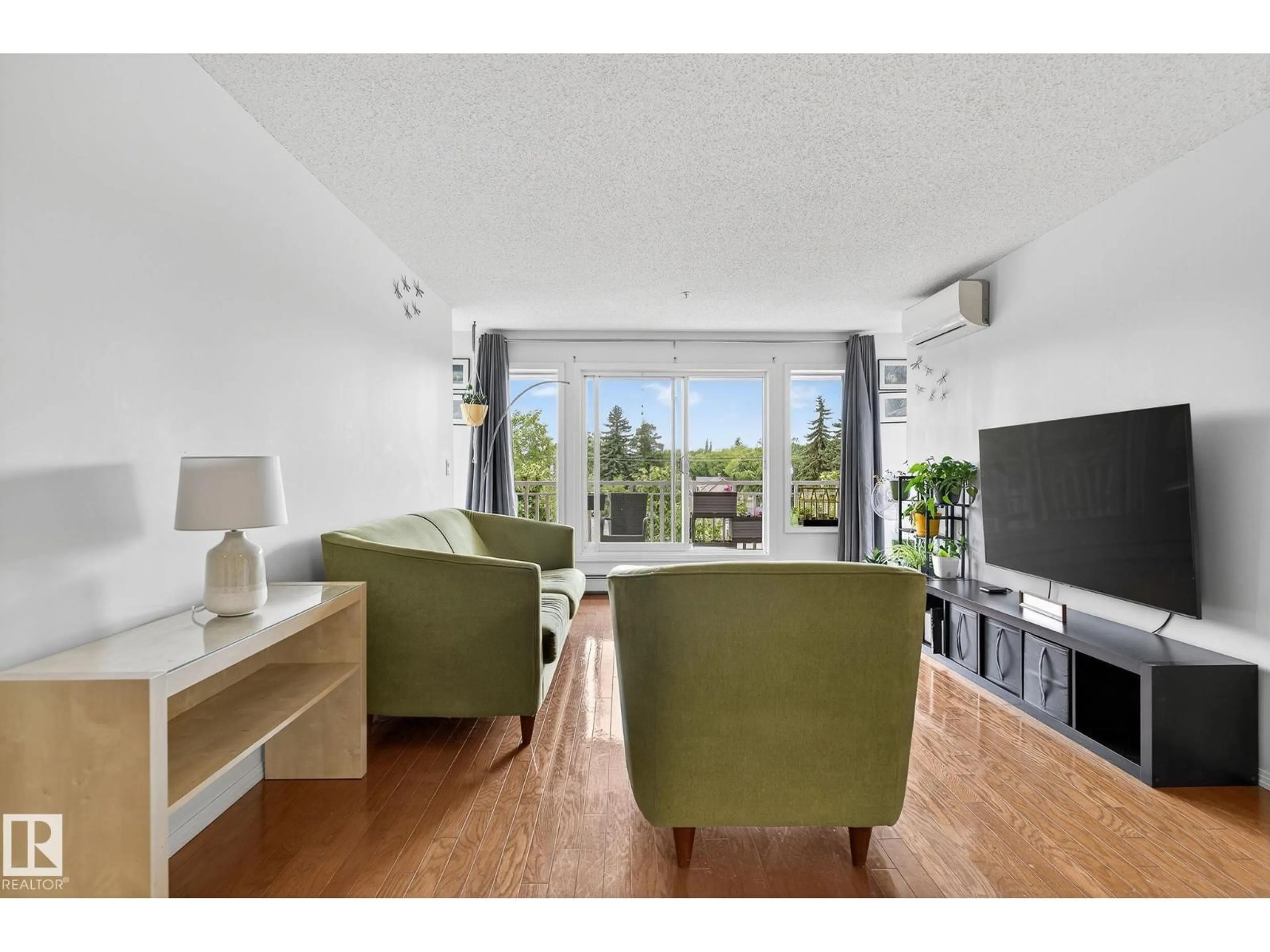 Living room with furniture, wood/laminate floor for 410 - 10951 124 ST NW, Edmonton Alberta T5M4E1