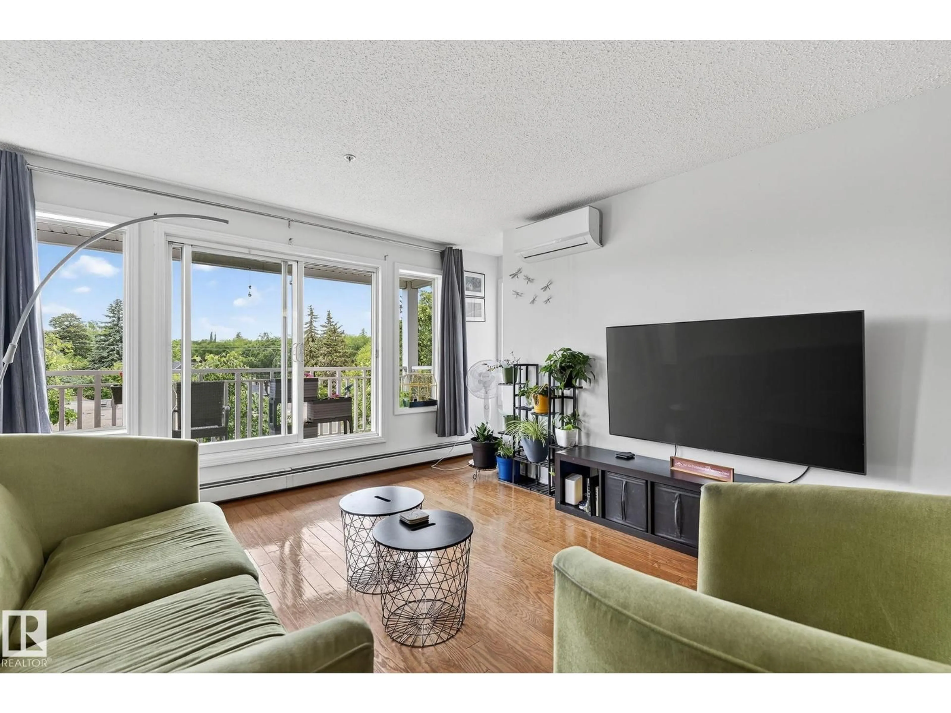 Living room with furniture, wood/laminate floor for 410 - 10951 124 ST NW, Edmonton Alberta T5M4E1
