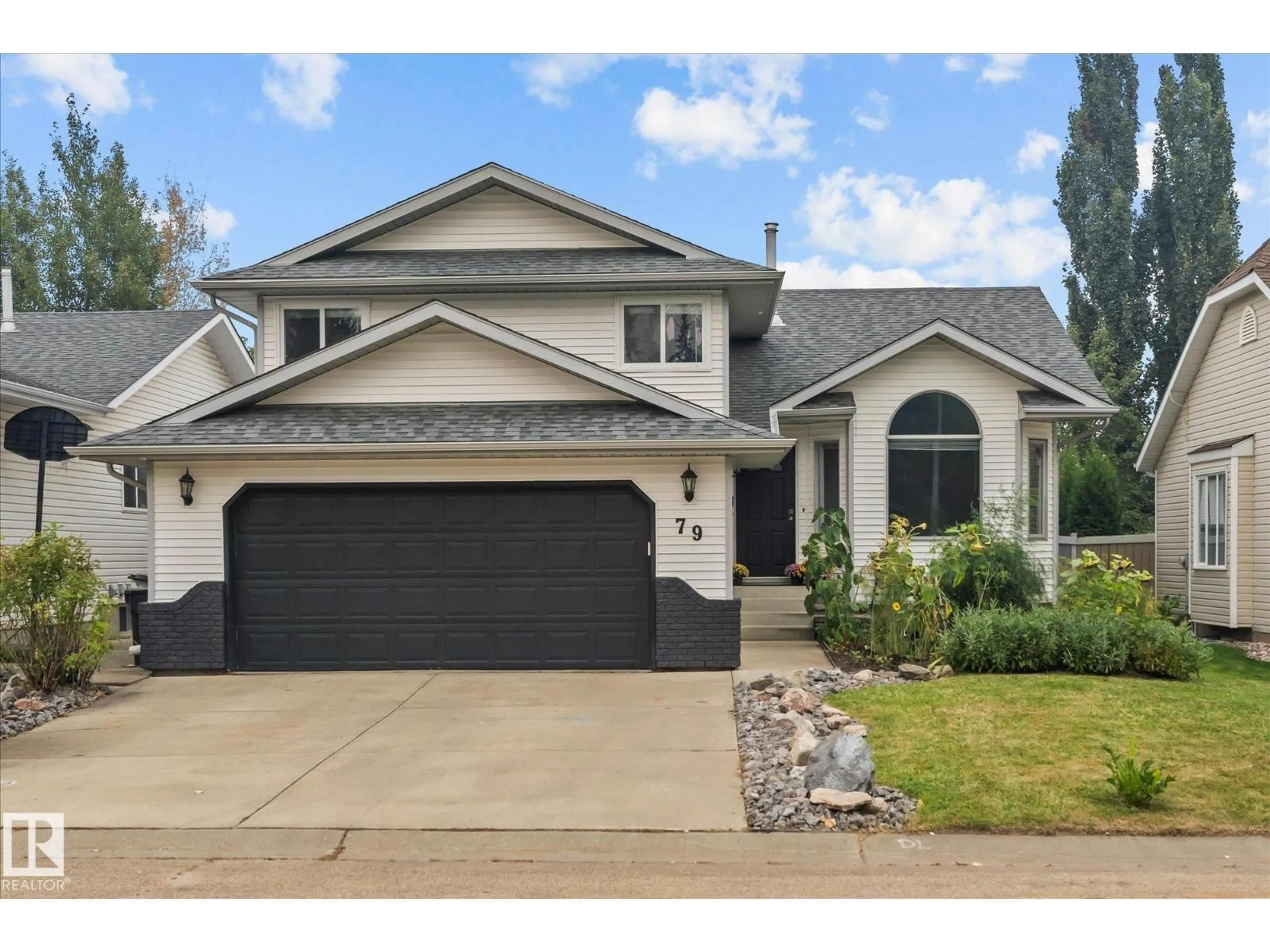 Home with vinyl exterior material, street for 79 WOODSIDE CR, Spruce Grove Alberta T7X3E6
