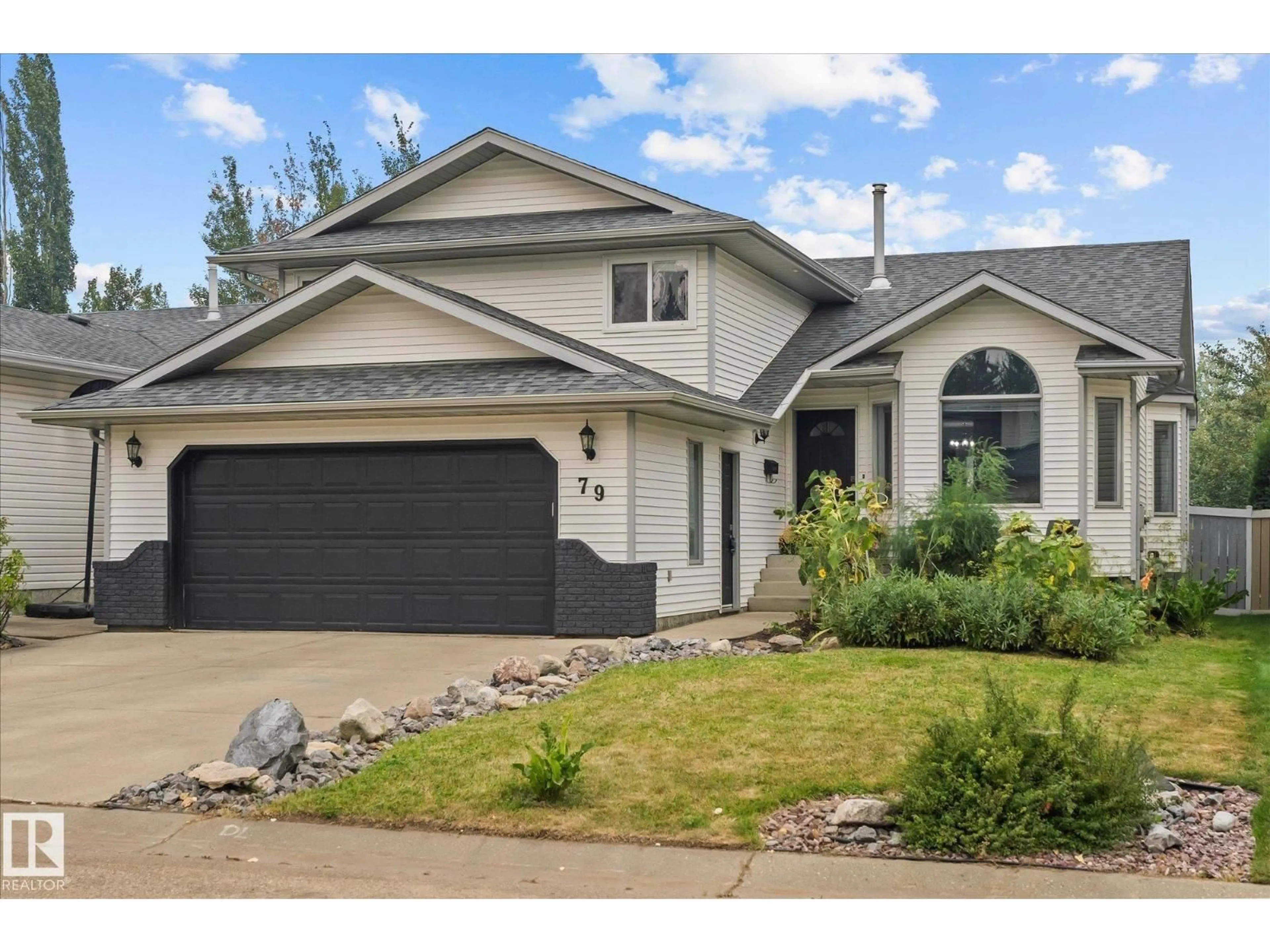 Home with vinyl exterior material, street for 79 WOODSIDE CR, Spruce Grove Alberta T7X3E6